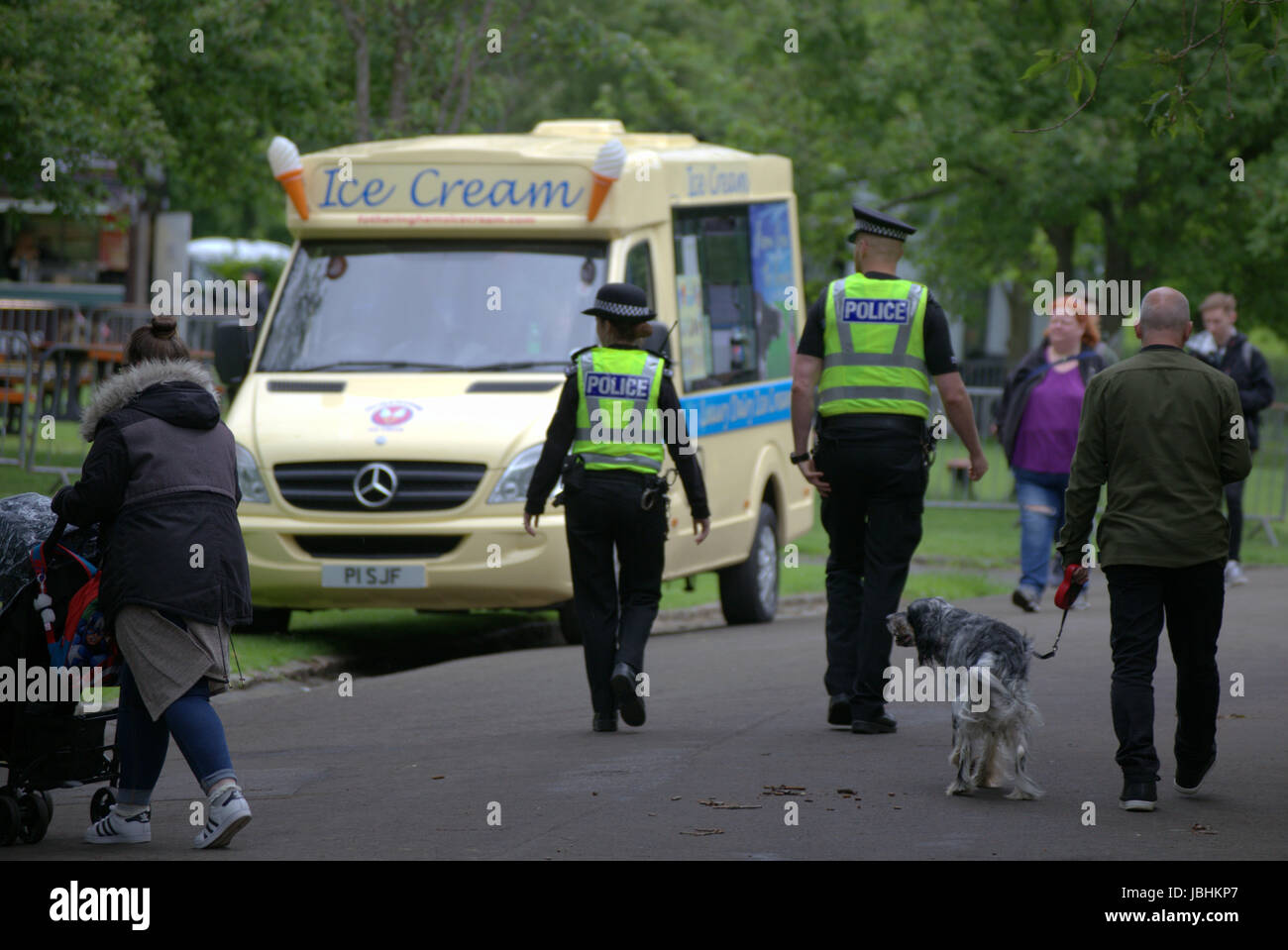 Glasgow, Scotland, UK. 11th June. The two elements of this years British summer were present as rain poured down on The West End Festival  Big Sunday in Kelvingrove Park. Visitors were heavily monitored by police and private security services. Armed police patrolled the park inside vehicles while bags were searched at entrances  by private security staff.  Police officers patrolled the venue on foot and bicycle.  Credit Gerard Ferry/Alamy Live News Stock Photo