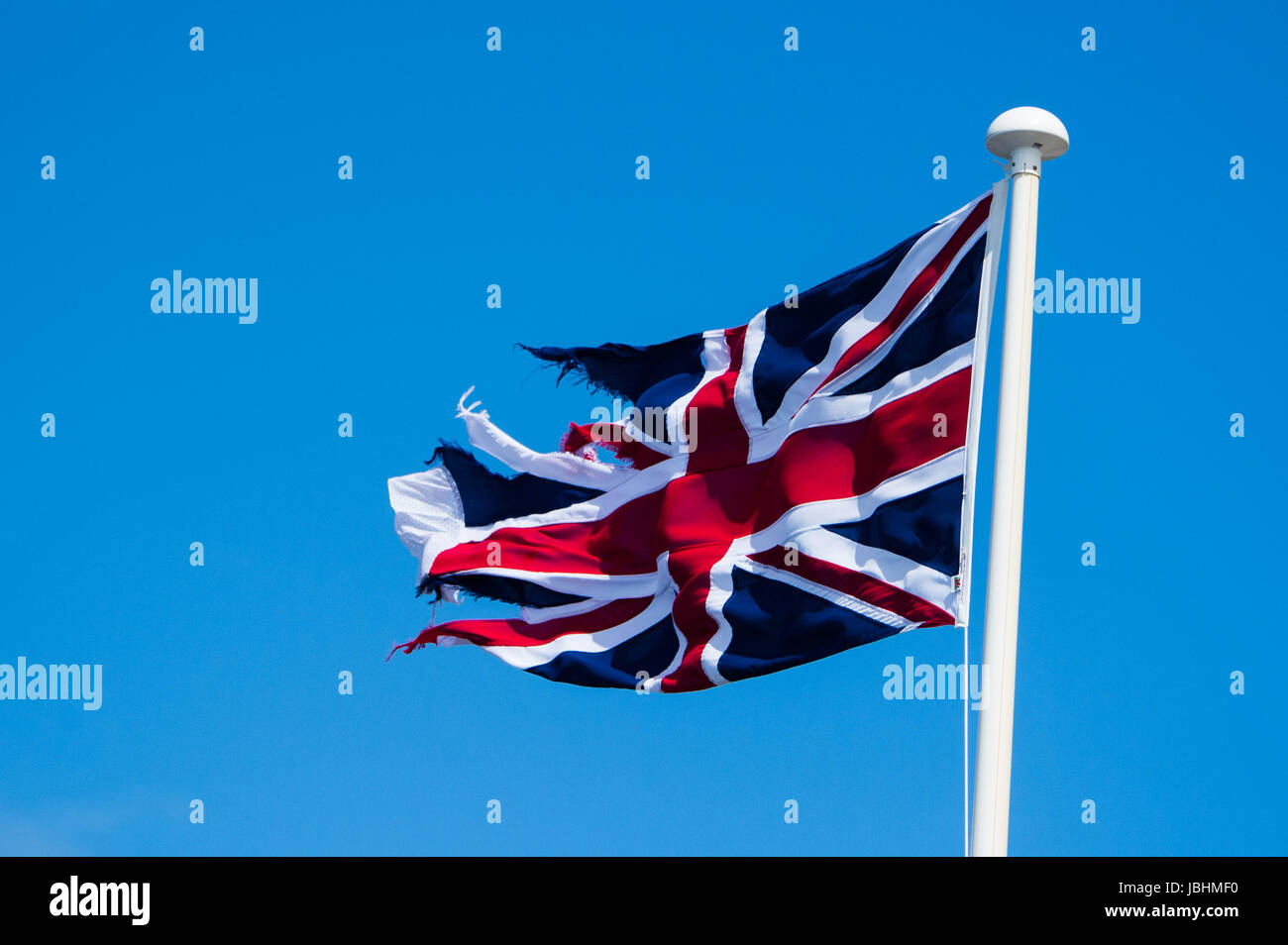 Aberystwyth Wales UK, Sunday 11 June 2017  UK Weather: The Union Jack  flag in tatters, blowing in the wind on a blustery summer sunday afternoon in Aberystwyth  on the Cardigan Bay coast of west  Wales  Photo credit: Keith Morris / ALAMY Live News Stock Photo