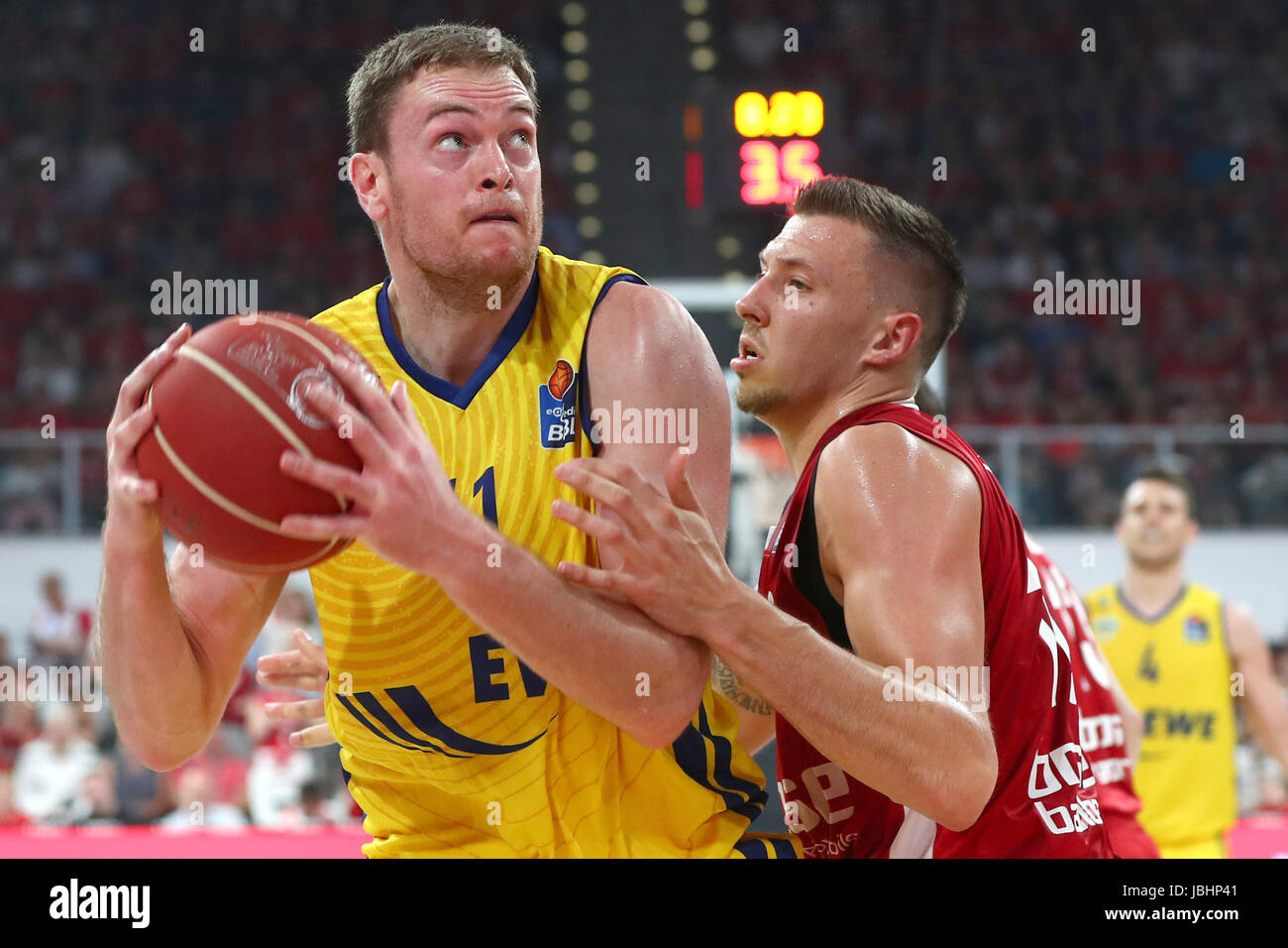 Bamberg'S Daniel Theis (r) blocks Oldenburg's Brian Qvale during the German Bundesliga