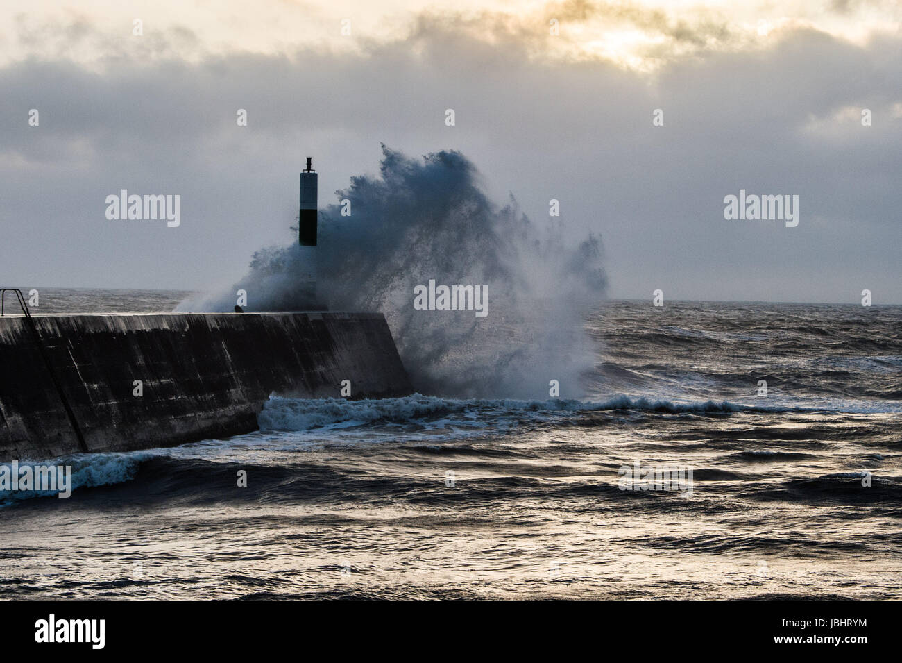 Aberystwyth Wales UK, Sunday 11 June 2017 UK Weather: Unseasonal gale force winds and high tides combine to bring huge waves crashing into the sea defences in Aberystwyth, Wales at the end of the day photo Credit: Keith Morris/Alamy Live News Stock Photo