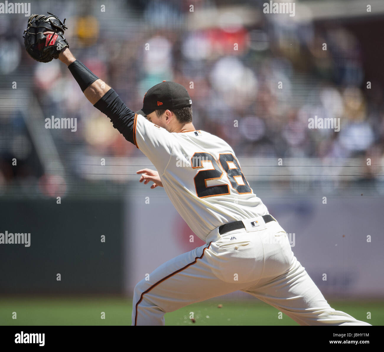 San Francisco, California, USA. 11th June, 2017. San Francisco Giants first baseman Buster Posey (28) makes the catch to beat Minnesota Twins designated hitter Robbie Grossman (36) (not shown) in the first inning during a MLB baseball game between the Minnesota Twins and the San Francisco Giants on ''Dog Days of Summer'' at AT&T Park in San Francisco, California. Valerie Shoaps/CSM/Alamy Live News Stock Photo