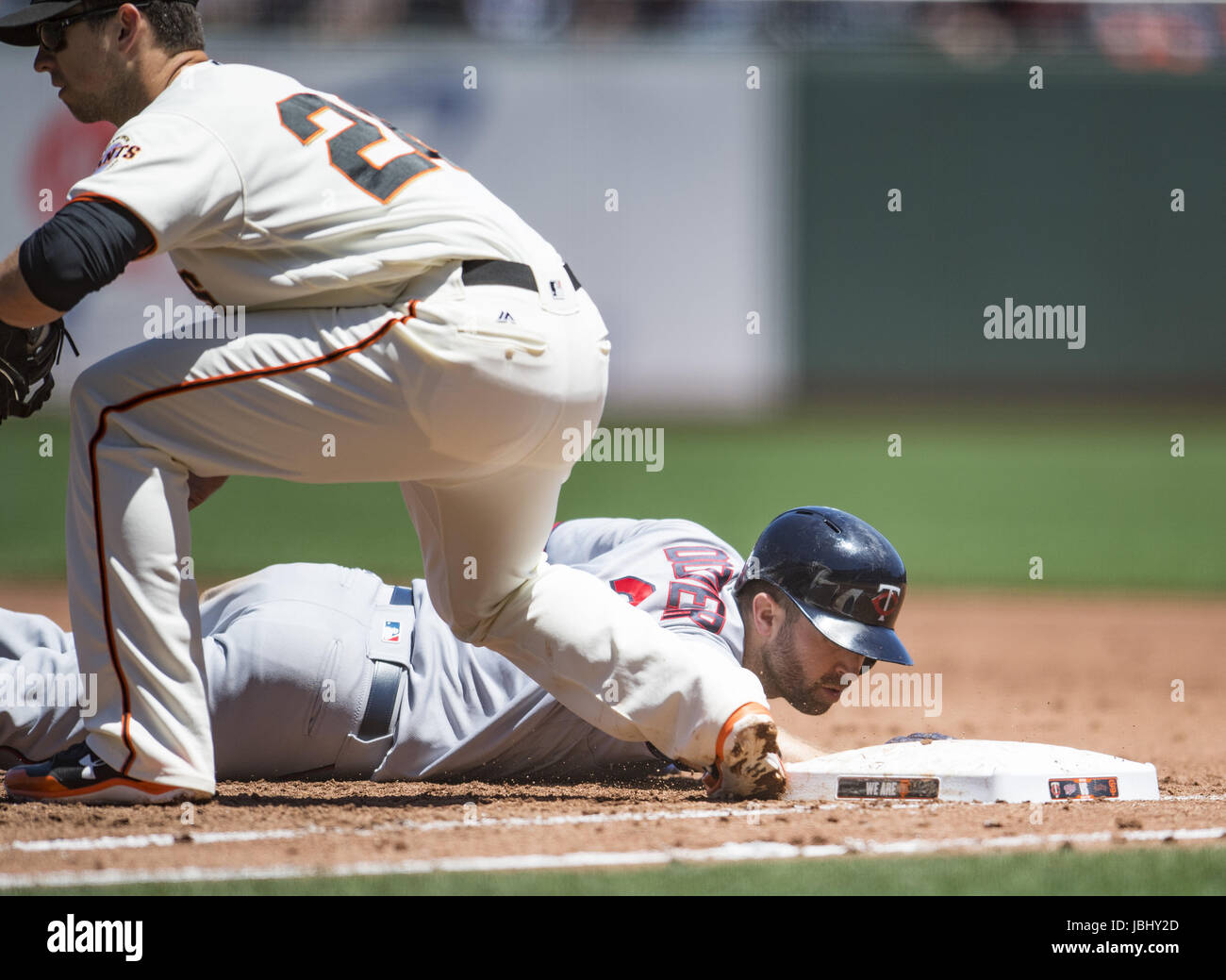 San Francisco, California, USA. 11th June, 2017. Minnesota Twins second baseman Brian Dozier (2) slides back into first base, during a MLB baseball game between the Minnesota Twins and the San Francisco Giants on ''Dog Days of Summer'' at AT&T Park in San Francisco, California. Valerie Shoaps/CSM/Alamy Live News Stock Photo