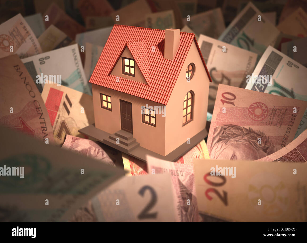 Small house surrounded by Brazilian money (Real) with deph of field. Stock Photo