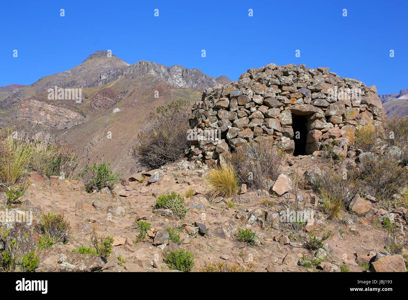 Pre-Incan round house named colca near Chivay in Peru. Colcas are circular stone structures used for food storage or burials. Stock Photo