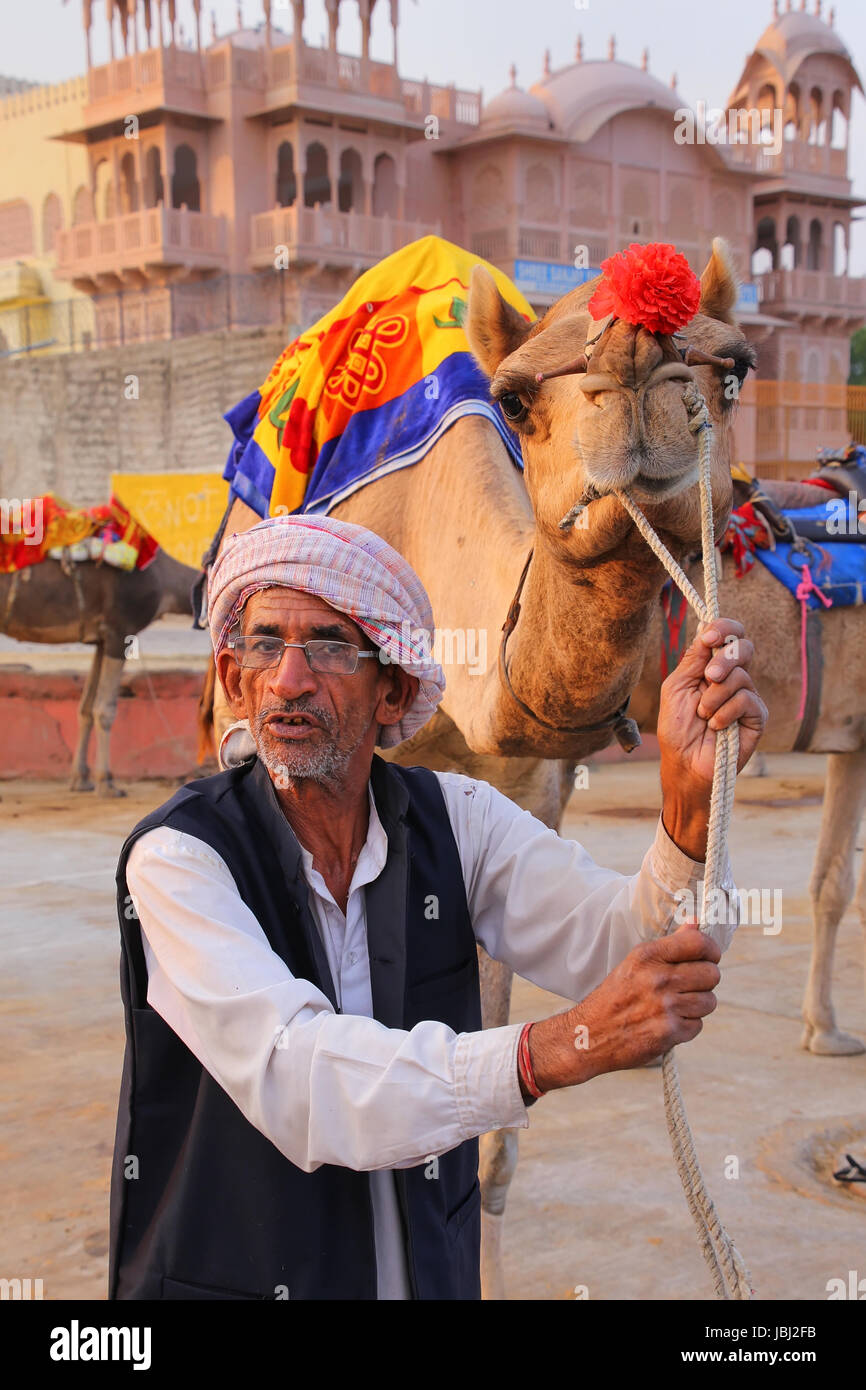 Indian mand standing with camel at Man Sagar Lake in Jaipur, Rajasthan, India. Stock Photo