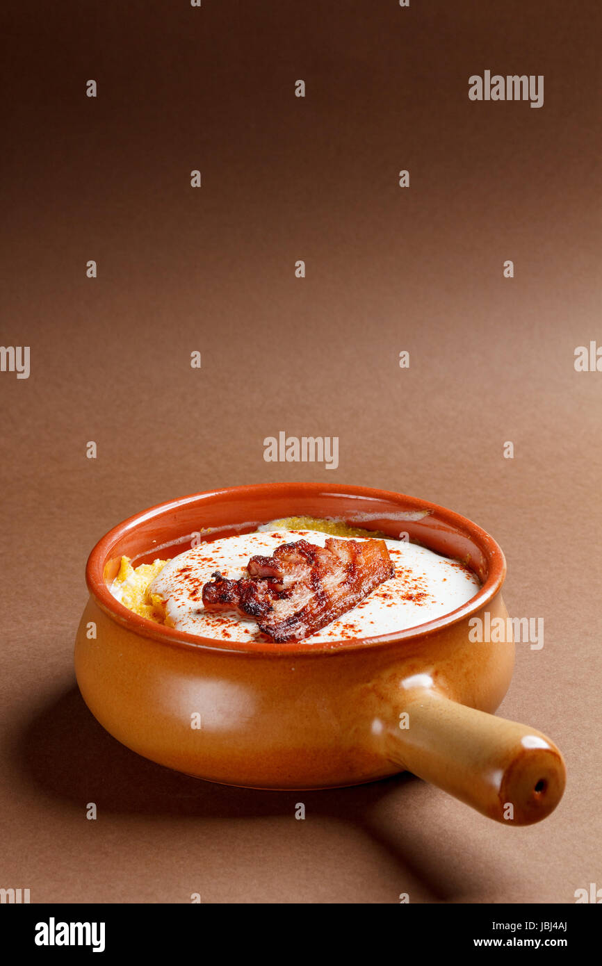 Romanian traditional dish of polenta with cheese and bacon Stock Photo