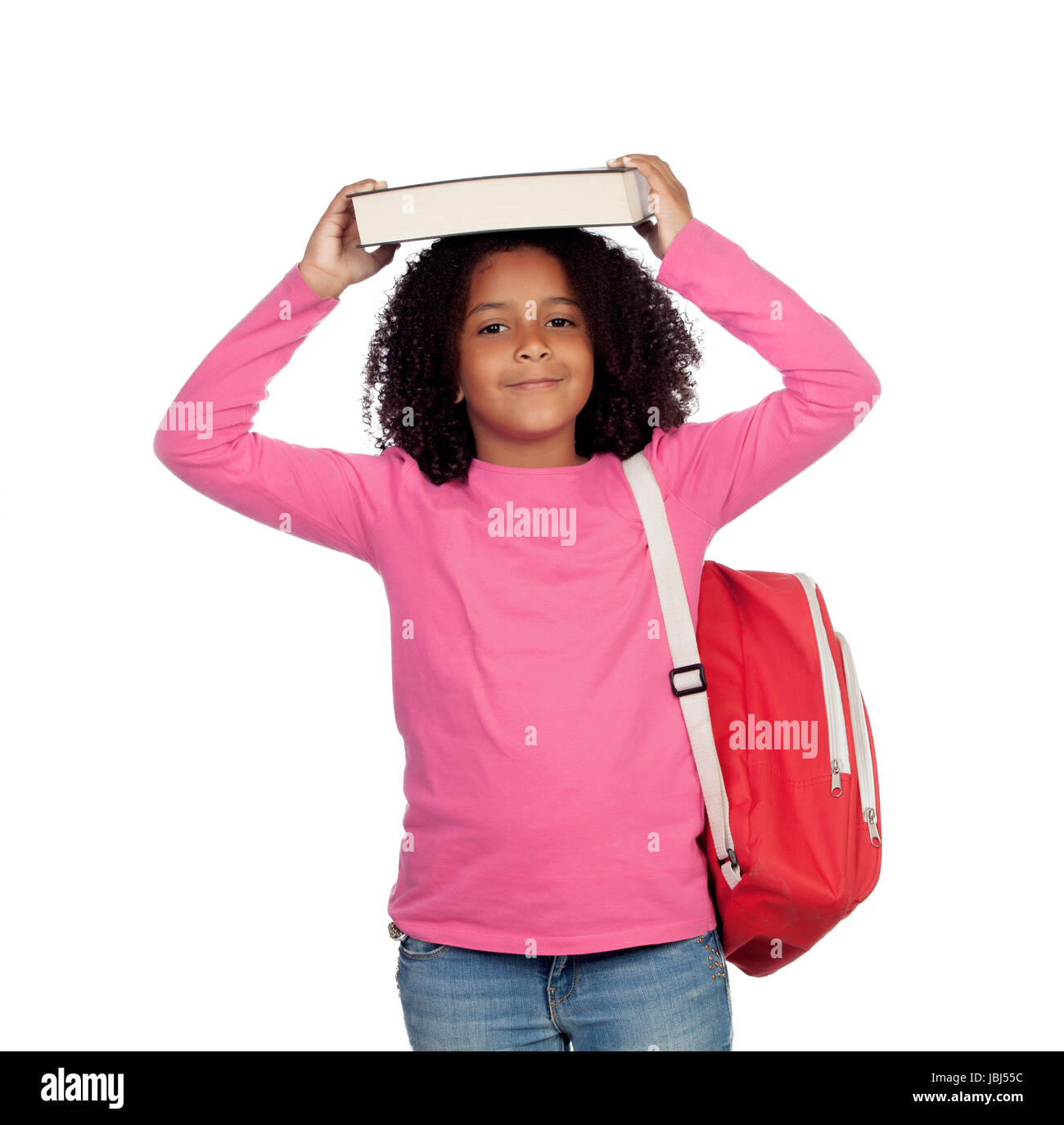 Little student girl with a book on her head isolated on a white ...