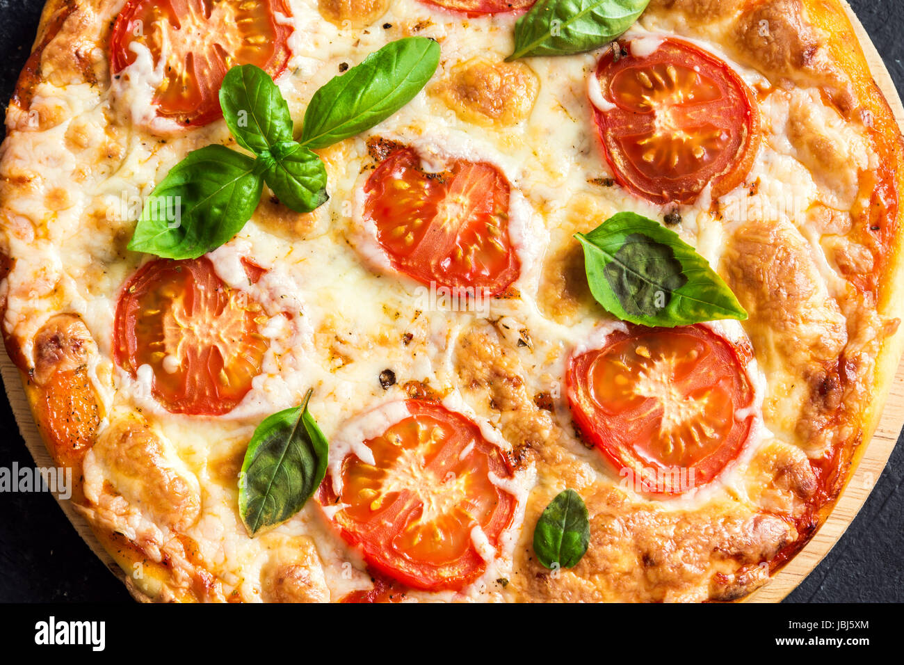Pizza Margherita On Black Stone Background Homemade Pizza Margarita With Tomatoes Basil And Mozzarella Cheese Stock Photo Alamy