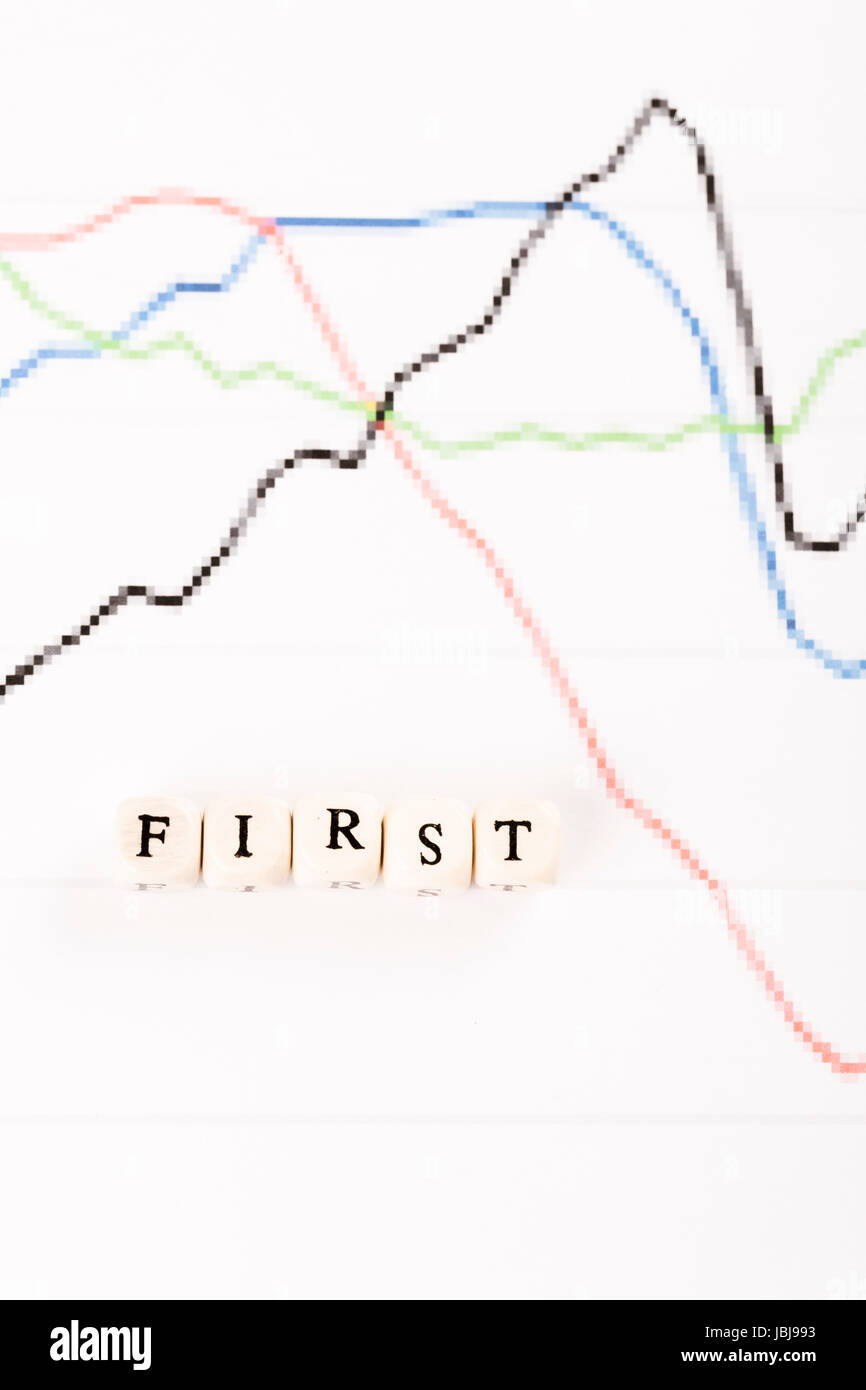 First written with wood cubes letters on financial business graph Stock ...