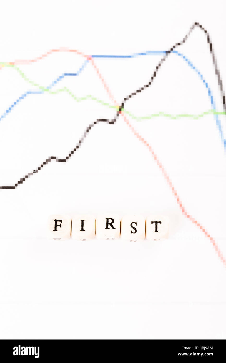 First written with wood cubes letters on financial business graph Stock ...