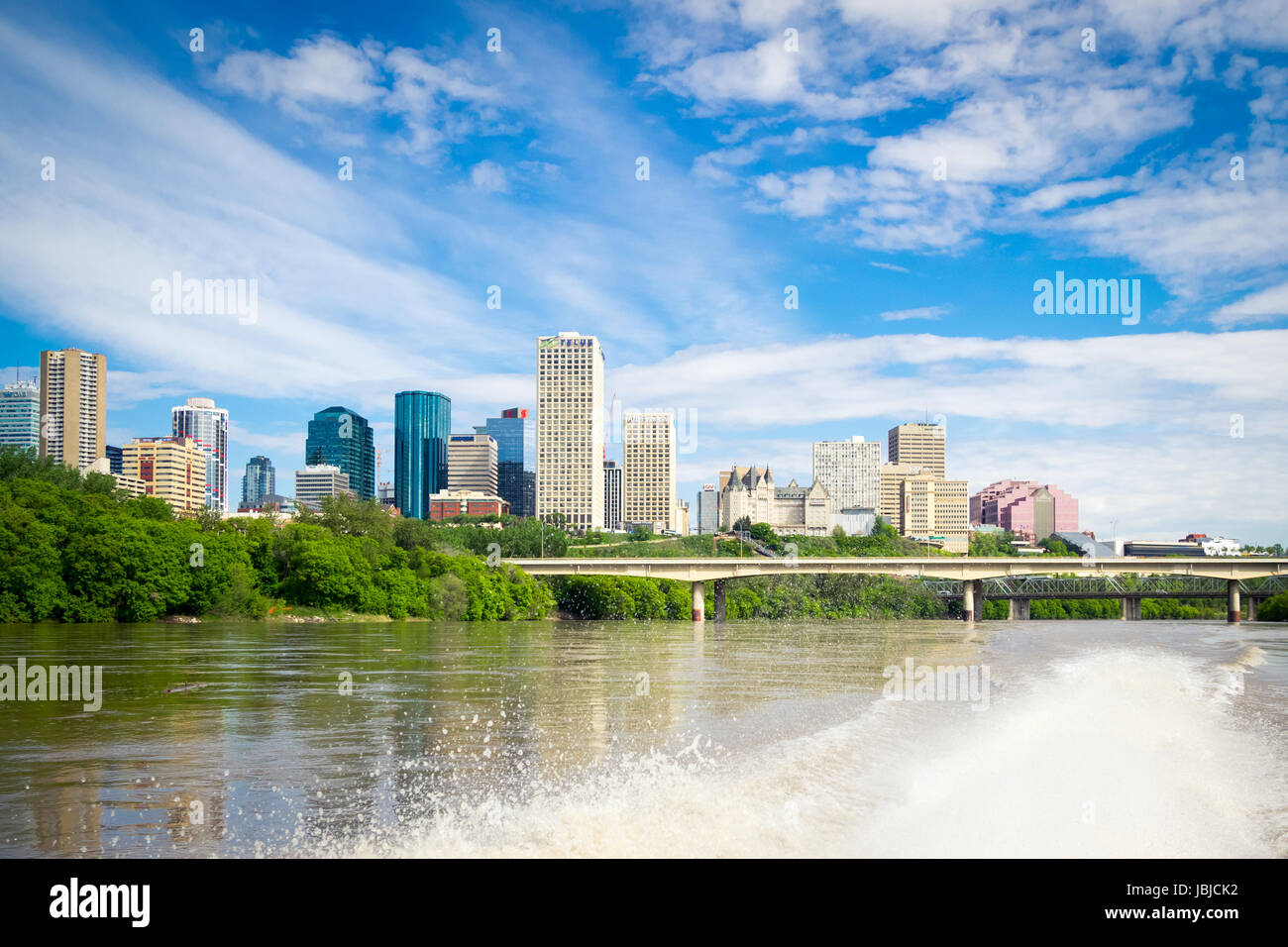 The summer skyline of the city of Edmonton, Alberta, Canada, as seen from a speedboat in the middle of the North Saskatchewan River. Stock Photo