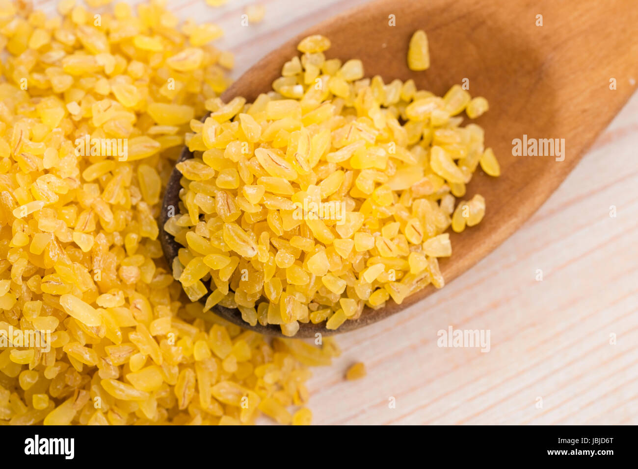 bulgur wheat in wooden spoon Stock Photo - Alamy