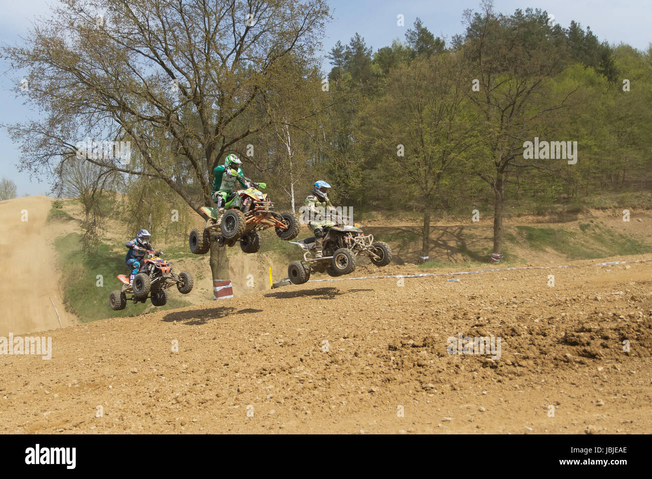 MOHELNICE,  CZECH REPUBLIC - APRIL 19: Trinity of quad riders are jumping a quad motorbike in the "International Championship of the Czech Republic 2014" on April 19, 2014  in MOHELNICE, Czech Republic. Stock Photo