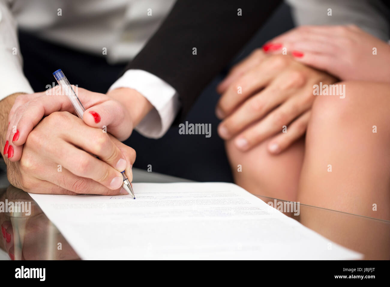 Man singning marriage settlement, prenuptial agreement, rich woman pulling into it Stock Photo