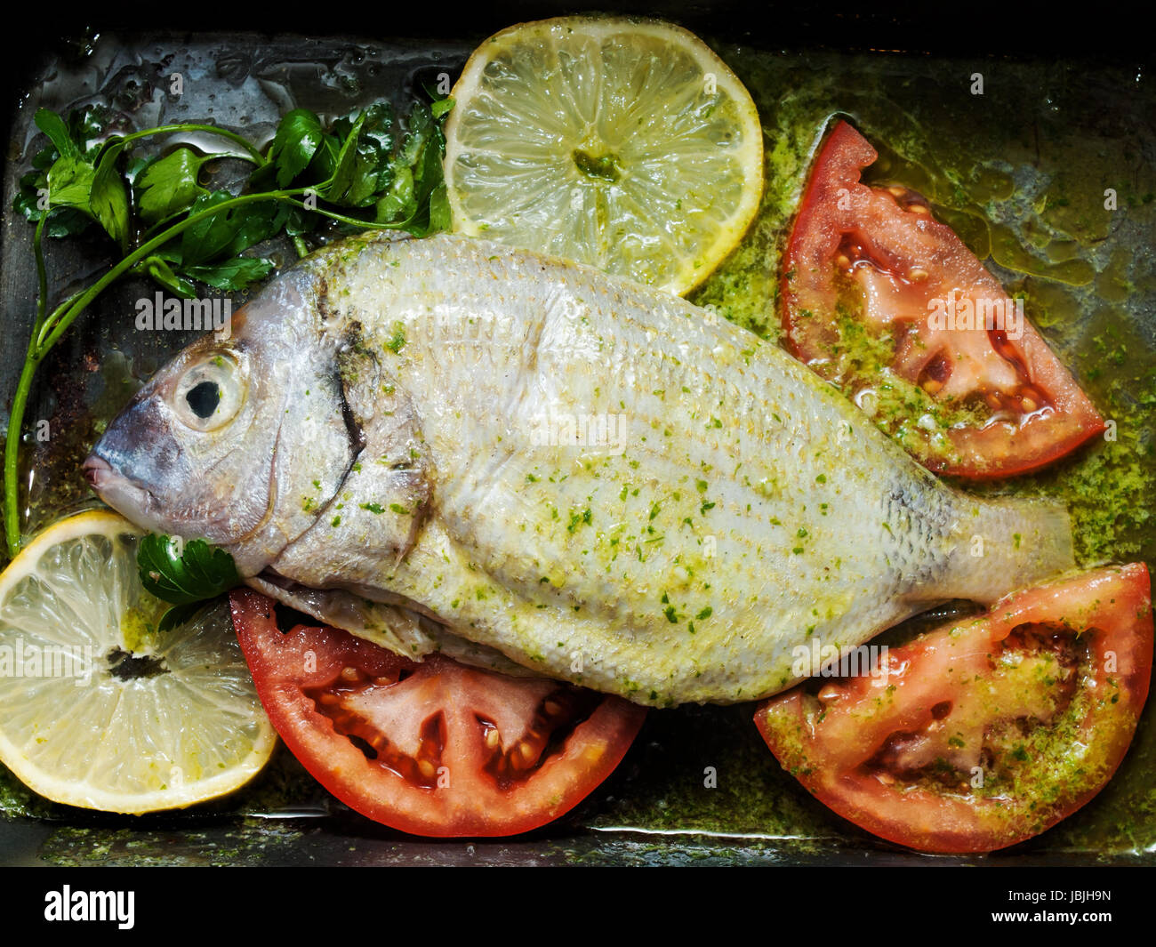 descaled fresh seabream fish marinated prepared for roasting Stock