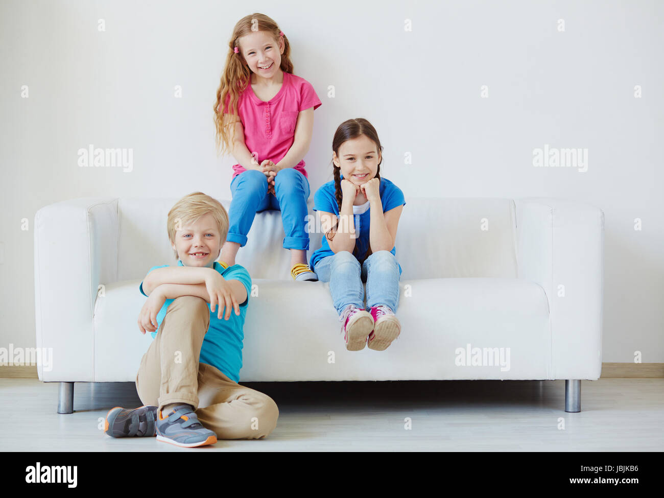 Three little friends looking at camera with smiles Stock Photo