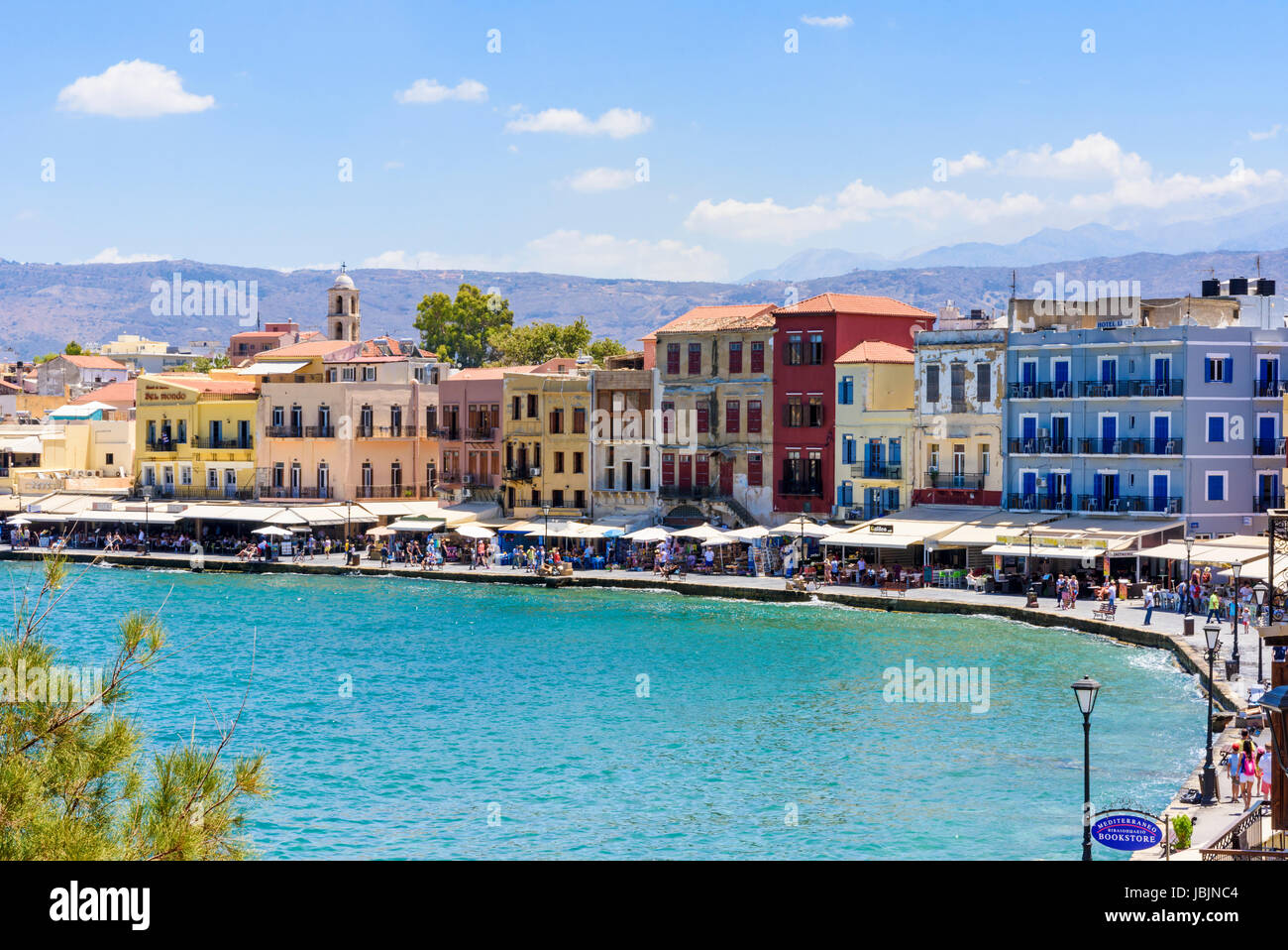 The Venetian harbour of Chania surrounded by cafés and restaurants along the waterfront promenade, Hania, Crete, Greece Stock Photo