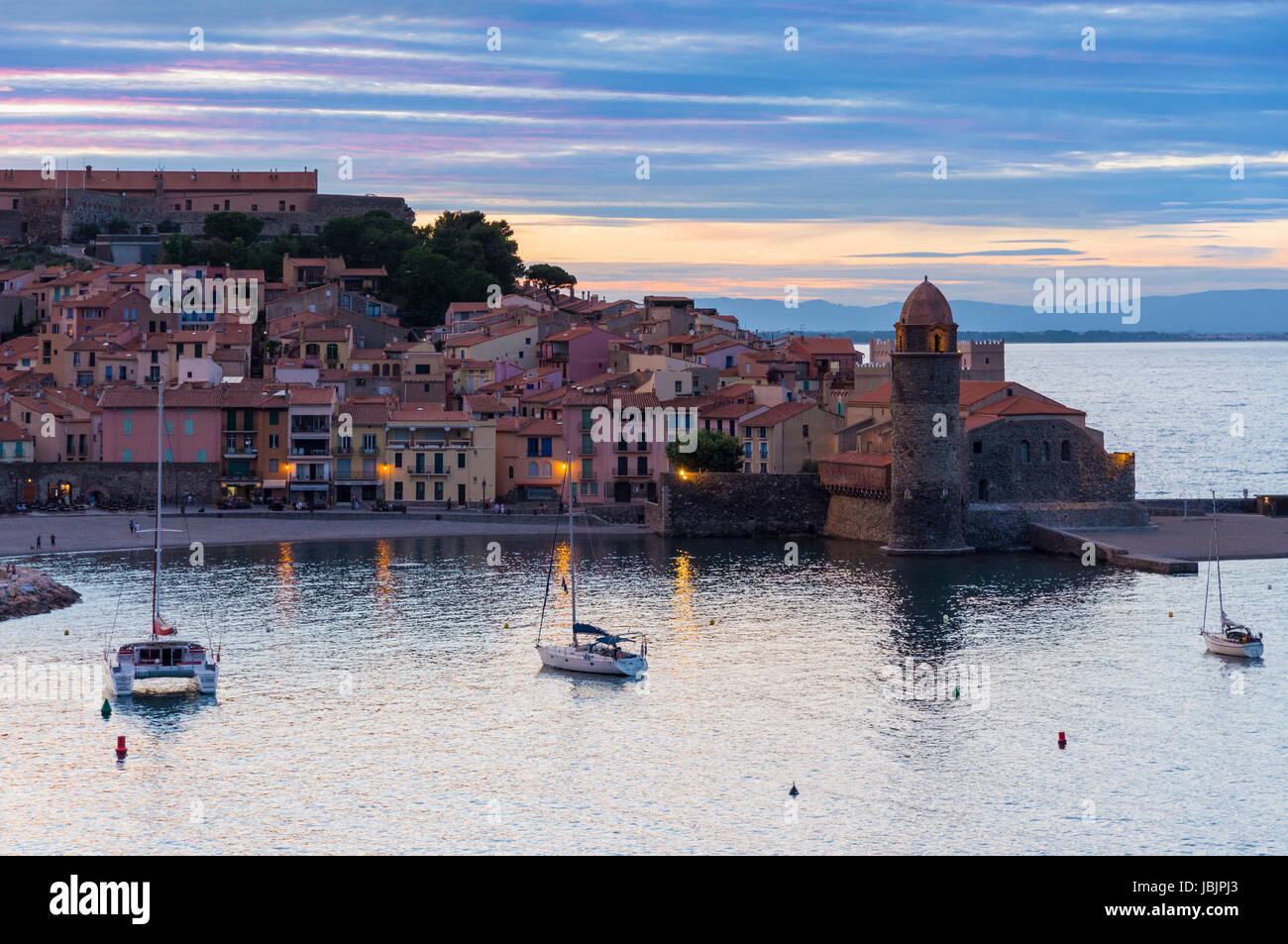 Sunset over the bell tower and Church of Notre Dame des Anges, Collioure, Côte Vermeille, France Stock Photo