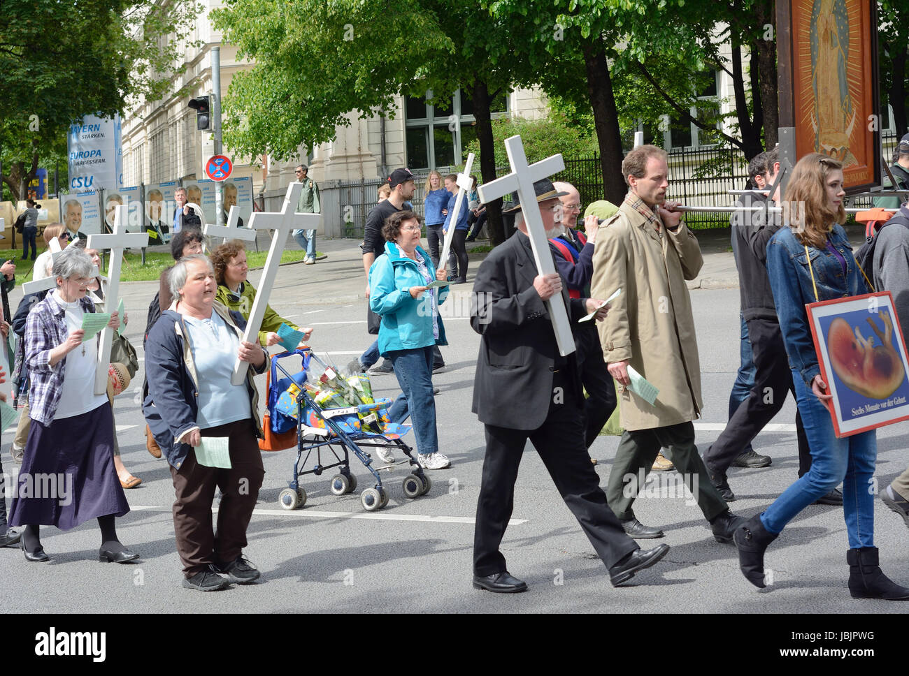MUNICH, GERMANY – MAY 10, 2014:  Anti-Abortion Demonstration with participants carrying Christian Crosses and banners.  Hundreds protested peacefully in Munich. Stock Photo