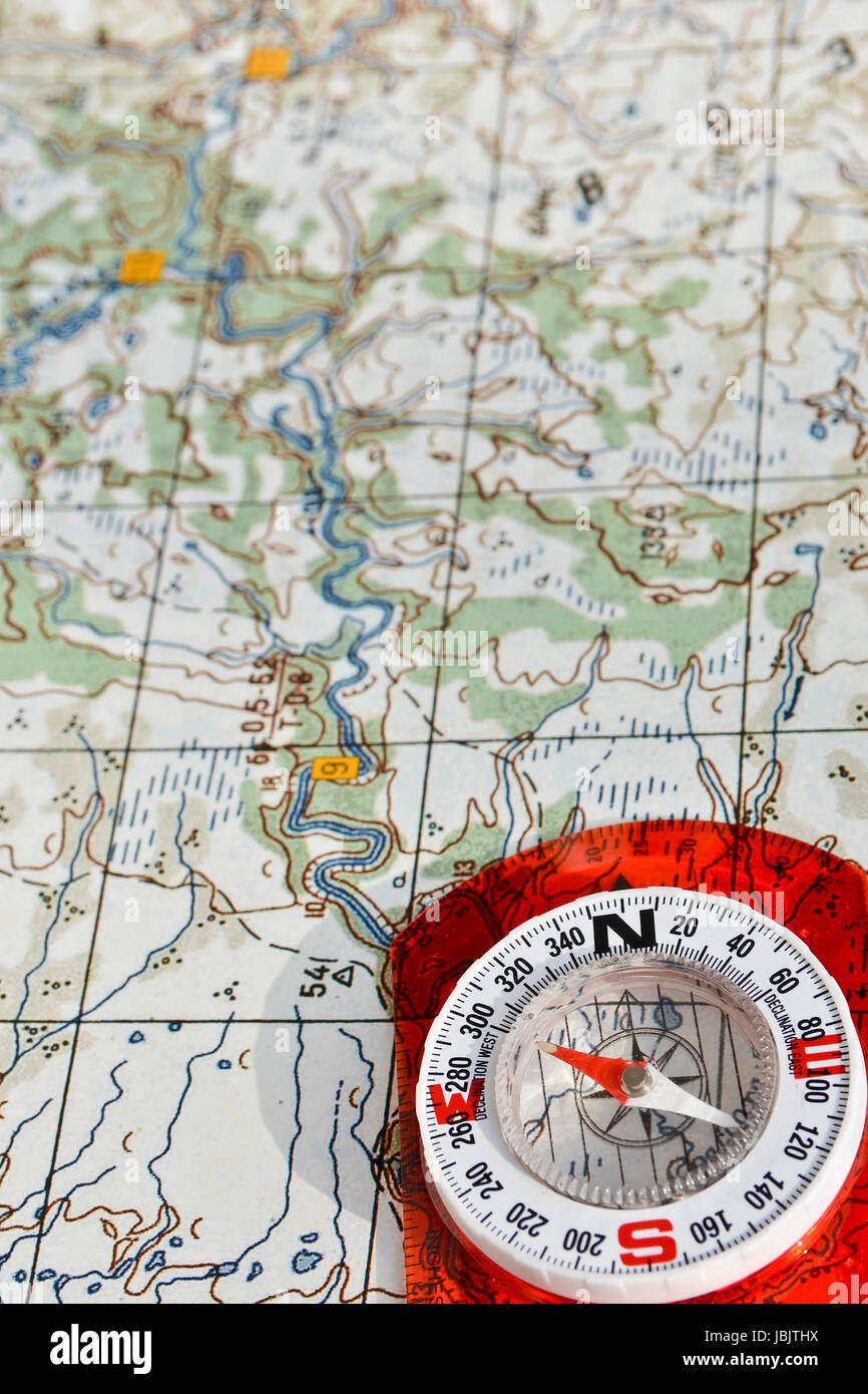 Compass on the map. Navigation tools to avoid getting lost. Stock Photo