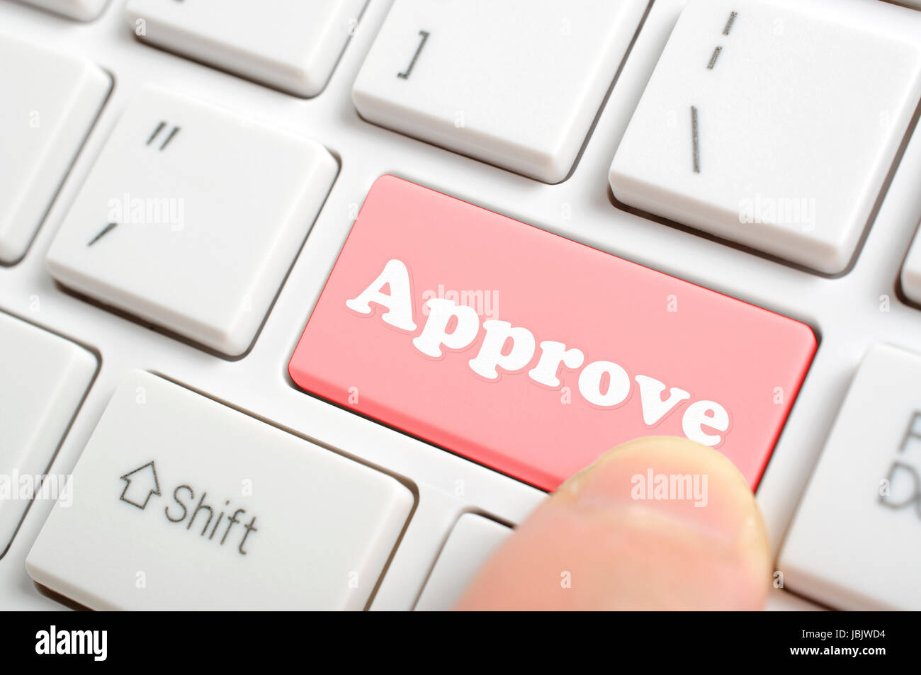 Woman pressing approve key on keyboard Stock Photo - Alamy