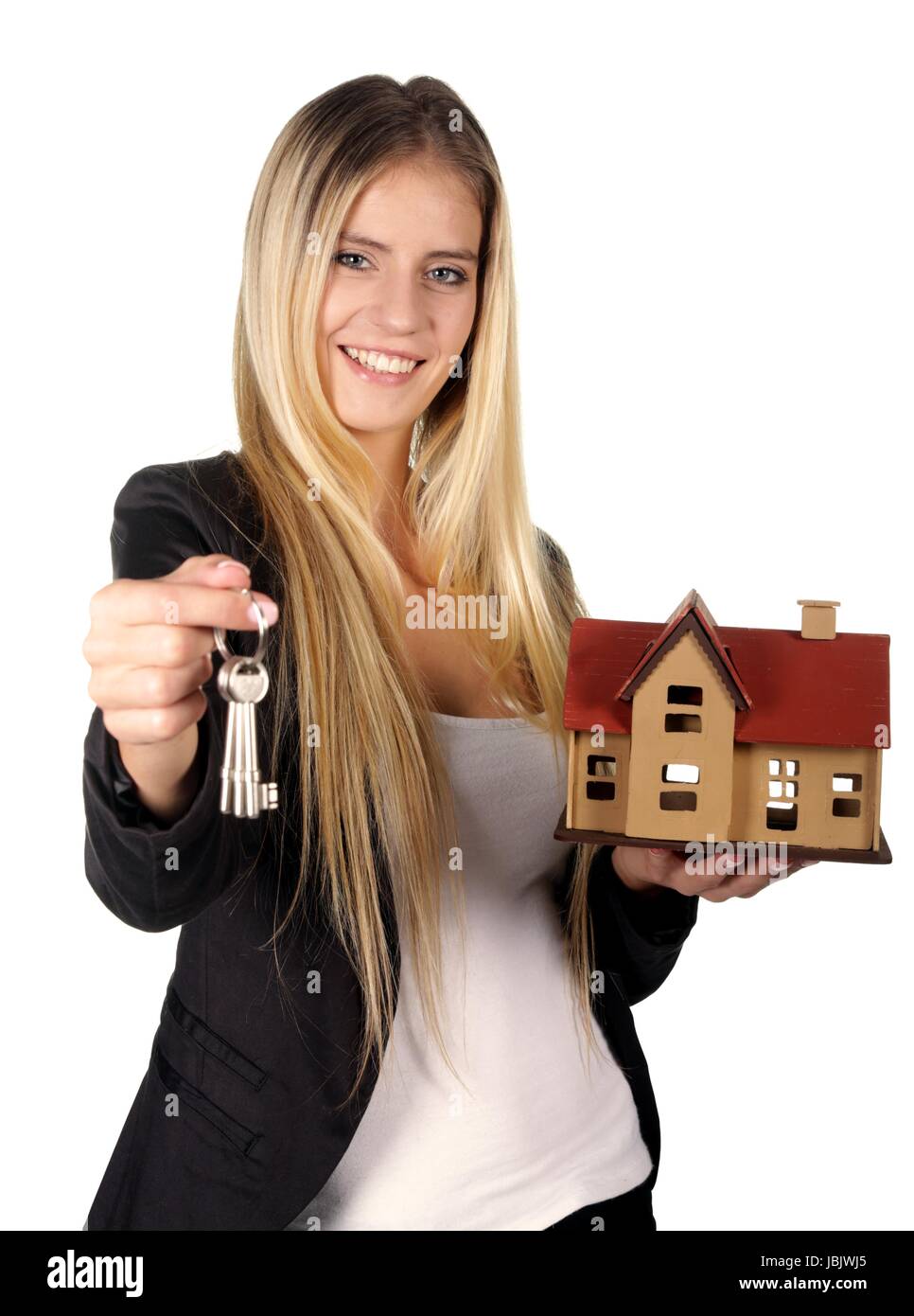 Pretty smiling estate agent woman with keys and model house Stock Photo ...