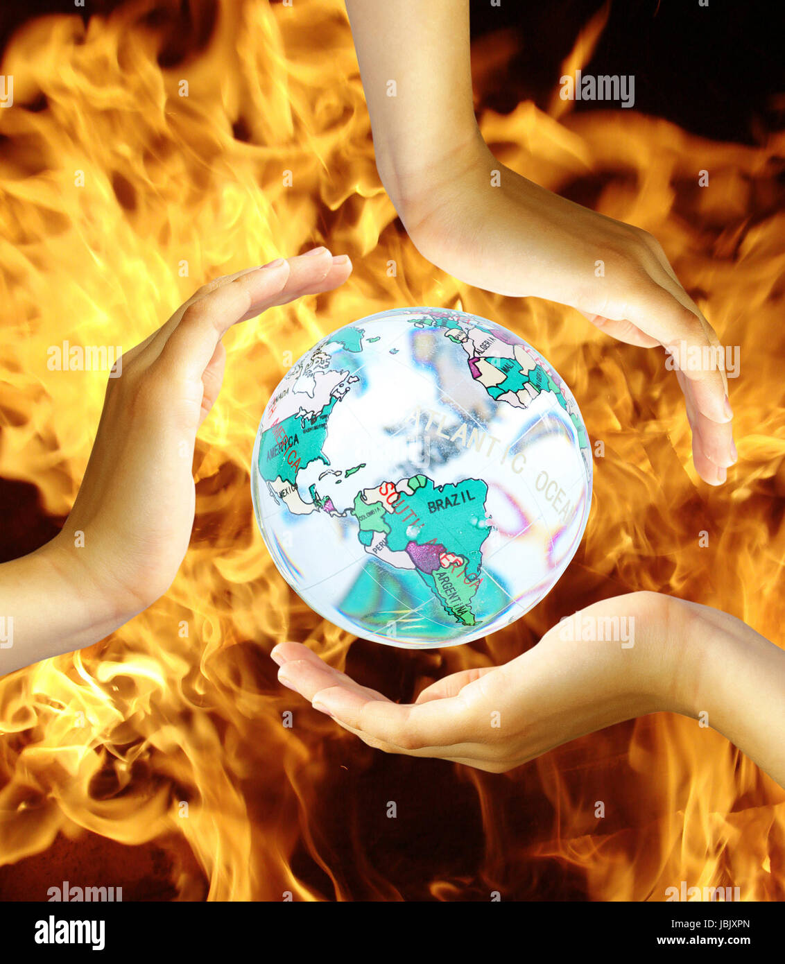Recycling symbol made from hands on  fire Stock Photo