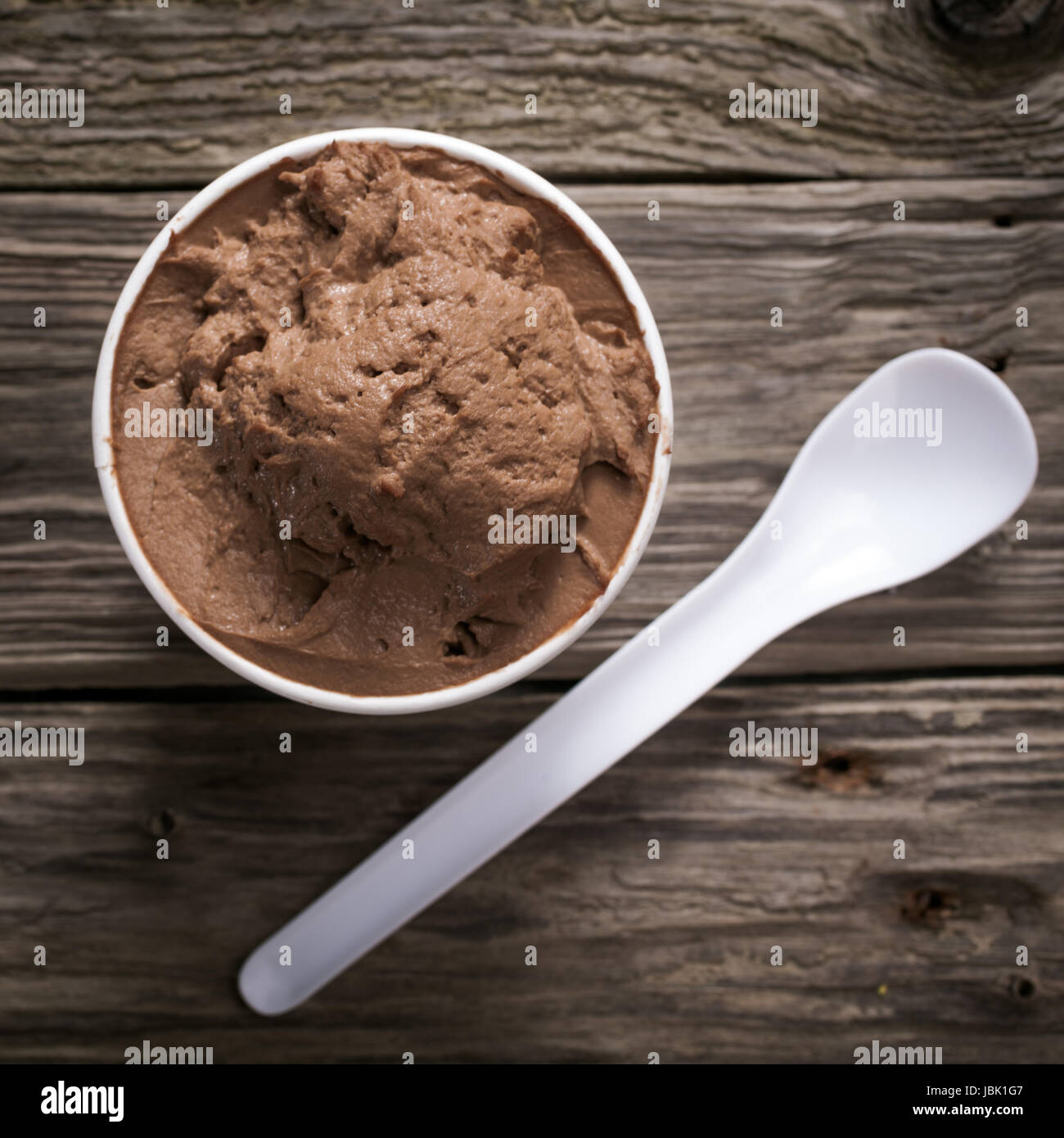 Empty tub of chocolate ice-cream with a plastic spoon Stock Photo - Alamy