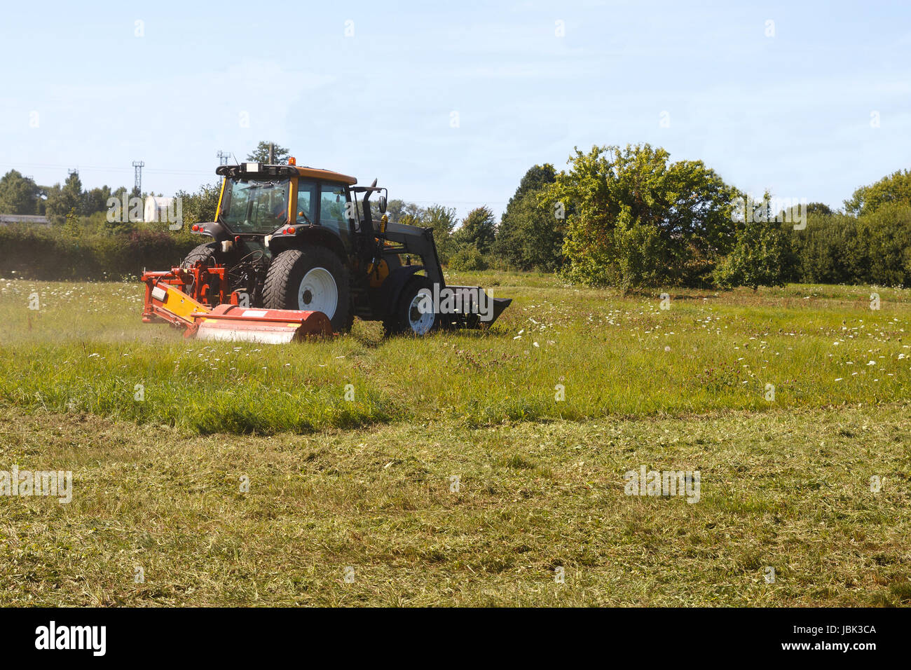 Tractor in field mows grass hi-res stock photography and images - Alamy