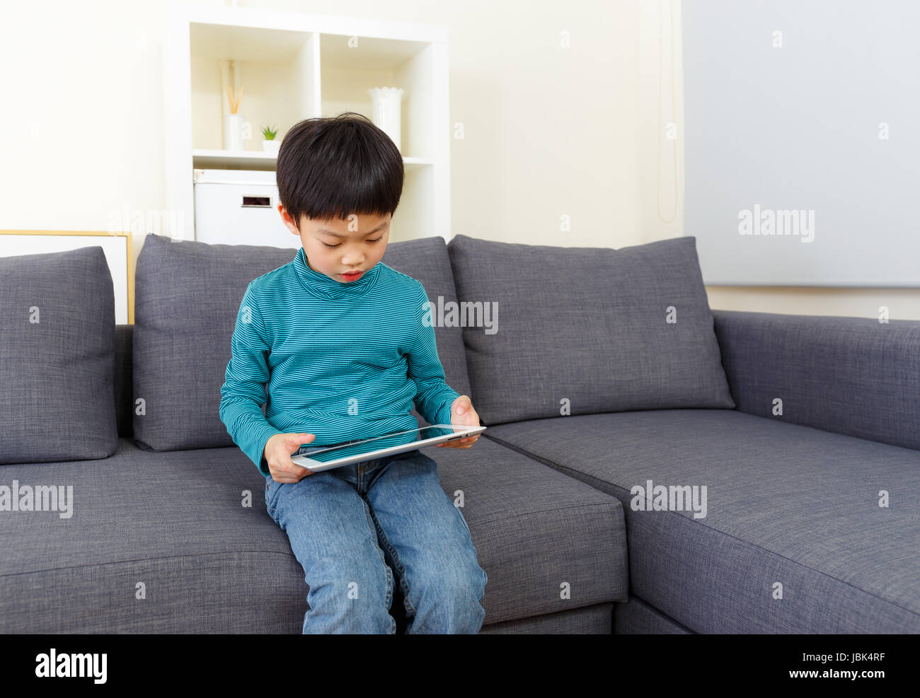 Little boy using tablet computer Stock Photo - Alamy
