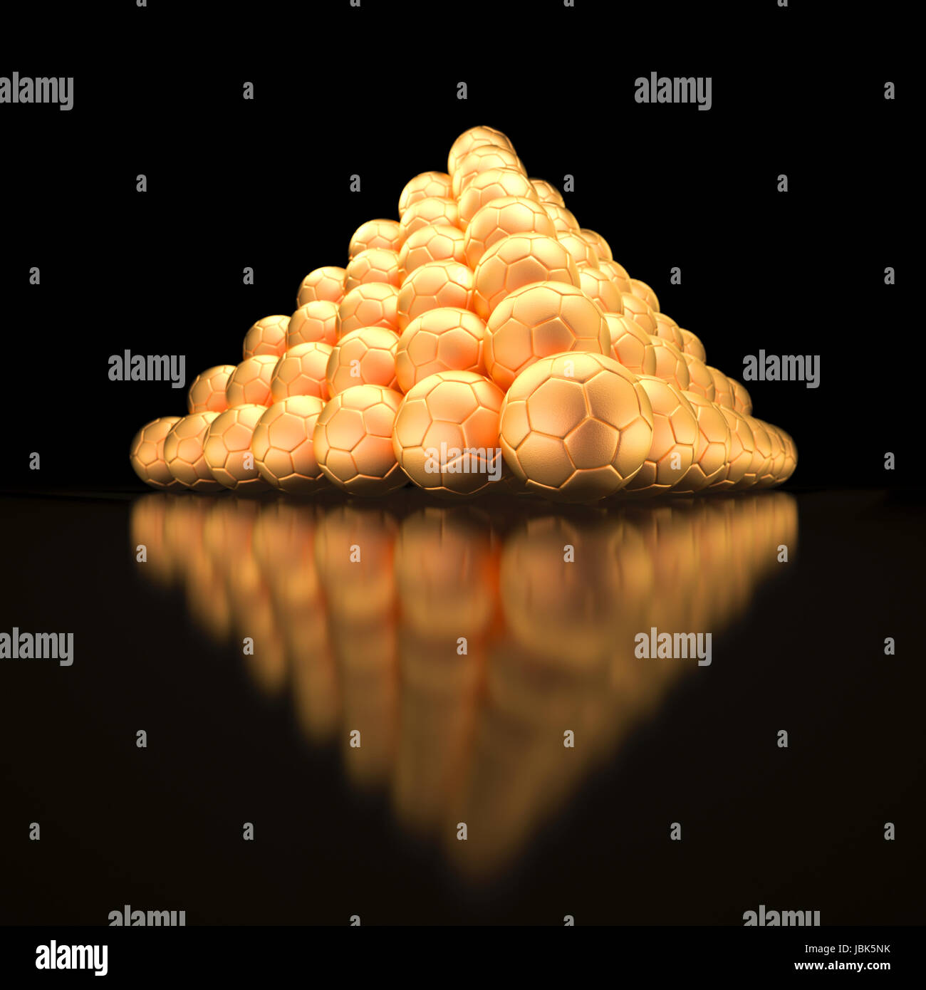 Pyramid made out of golden soccer balls on black background and black floor with strong reflections symbol for success and triumph Stock Photo