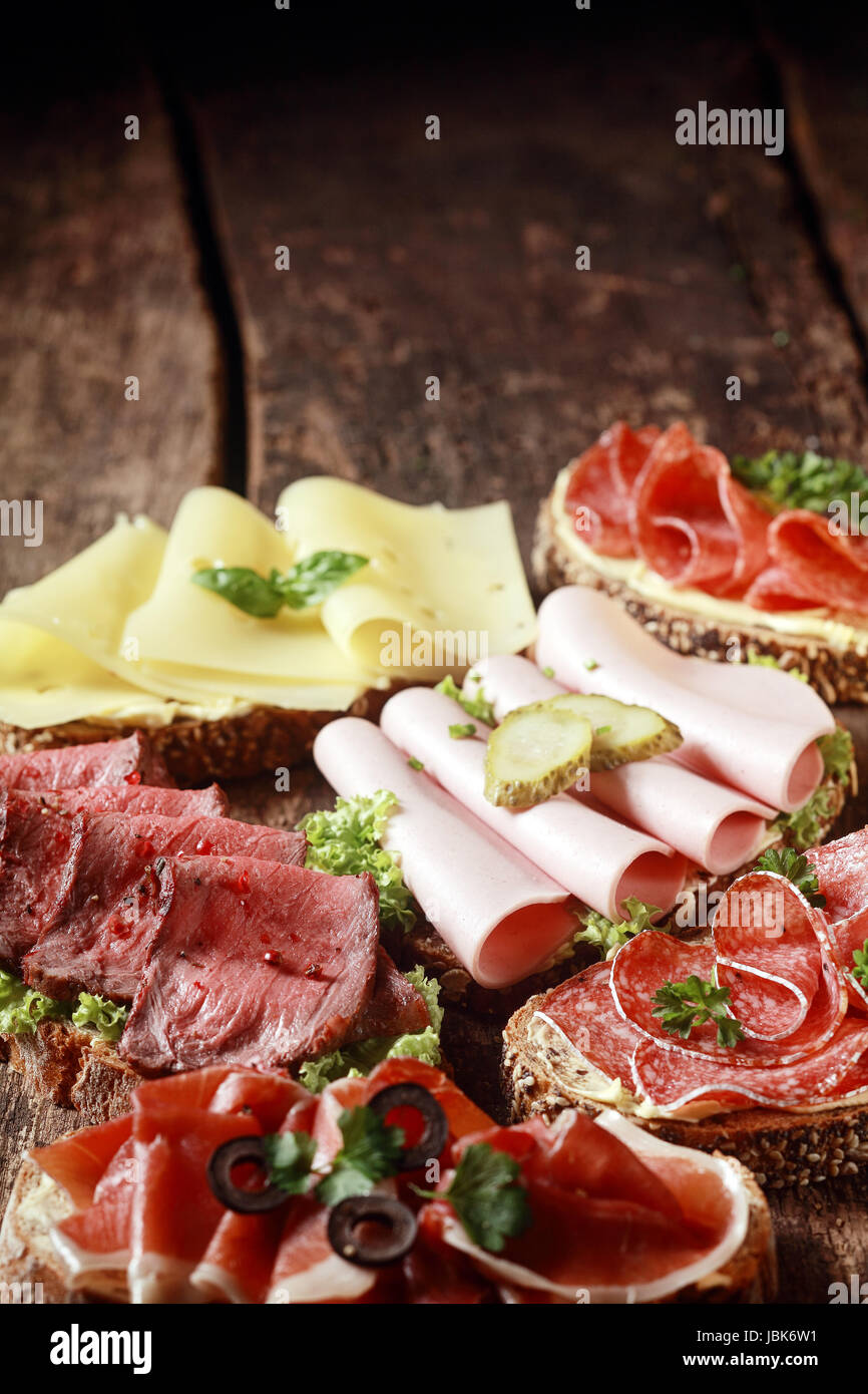 Assorted meat and cheese sandwiches with rare roast beef, mortadella