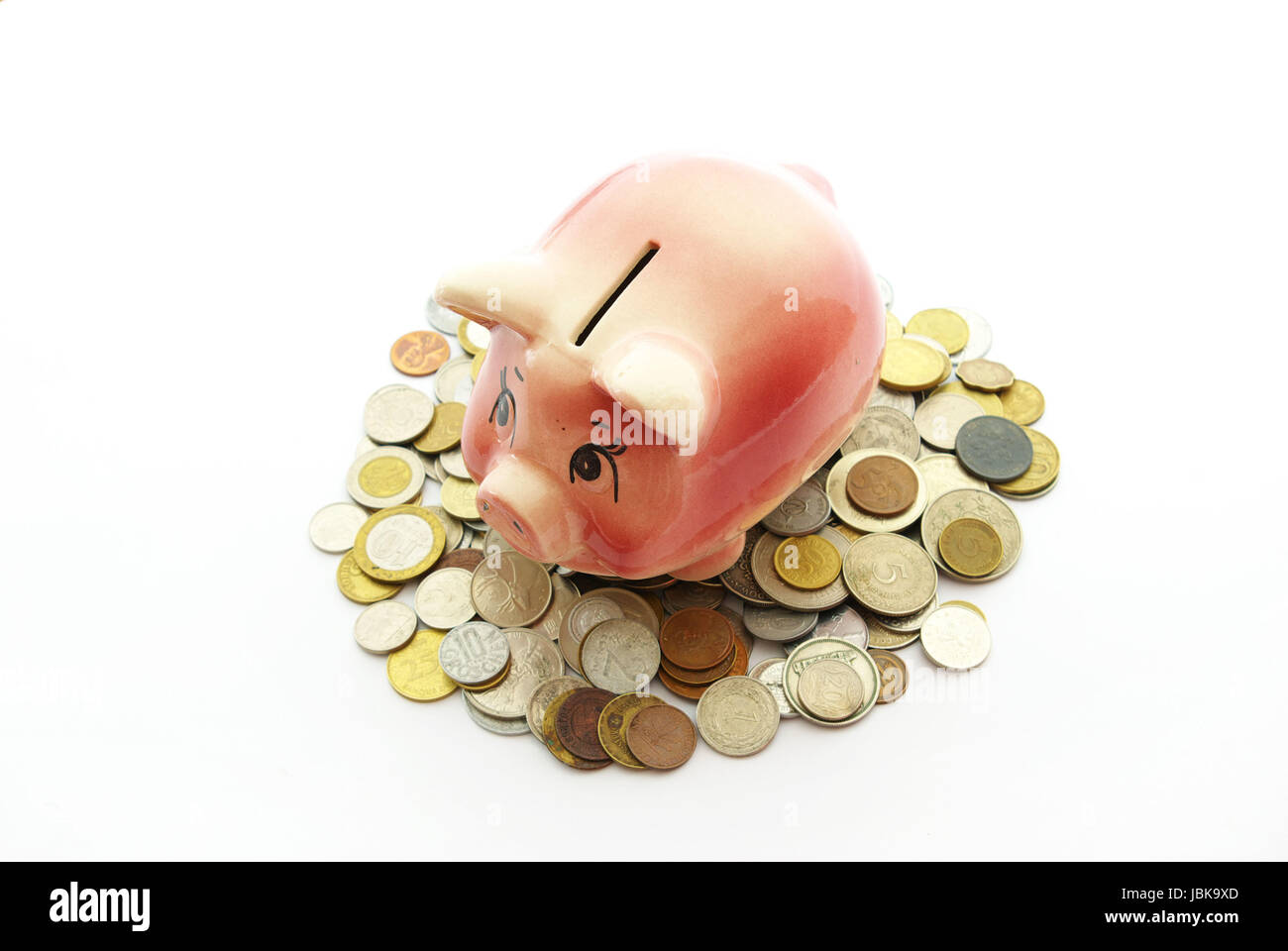 Pink piggy bank isolated on white background with coins Stock Photo - Alamy