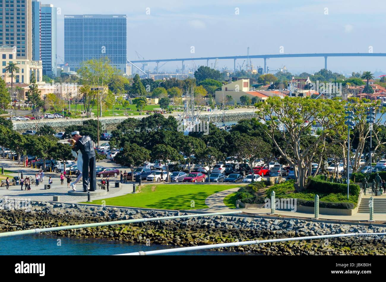 A view of the Unconditional surrender statue in Downtown San Diego marina in southern California in the United States of America. Some of the local arcitecture, commercial buildings and the coronado bridge in the city. Stock Photo