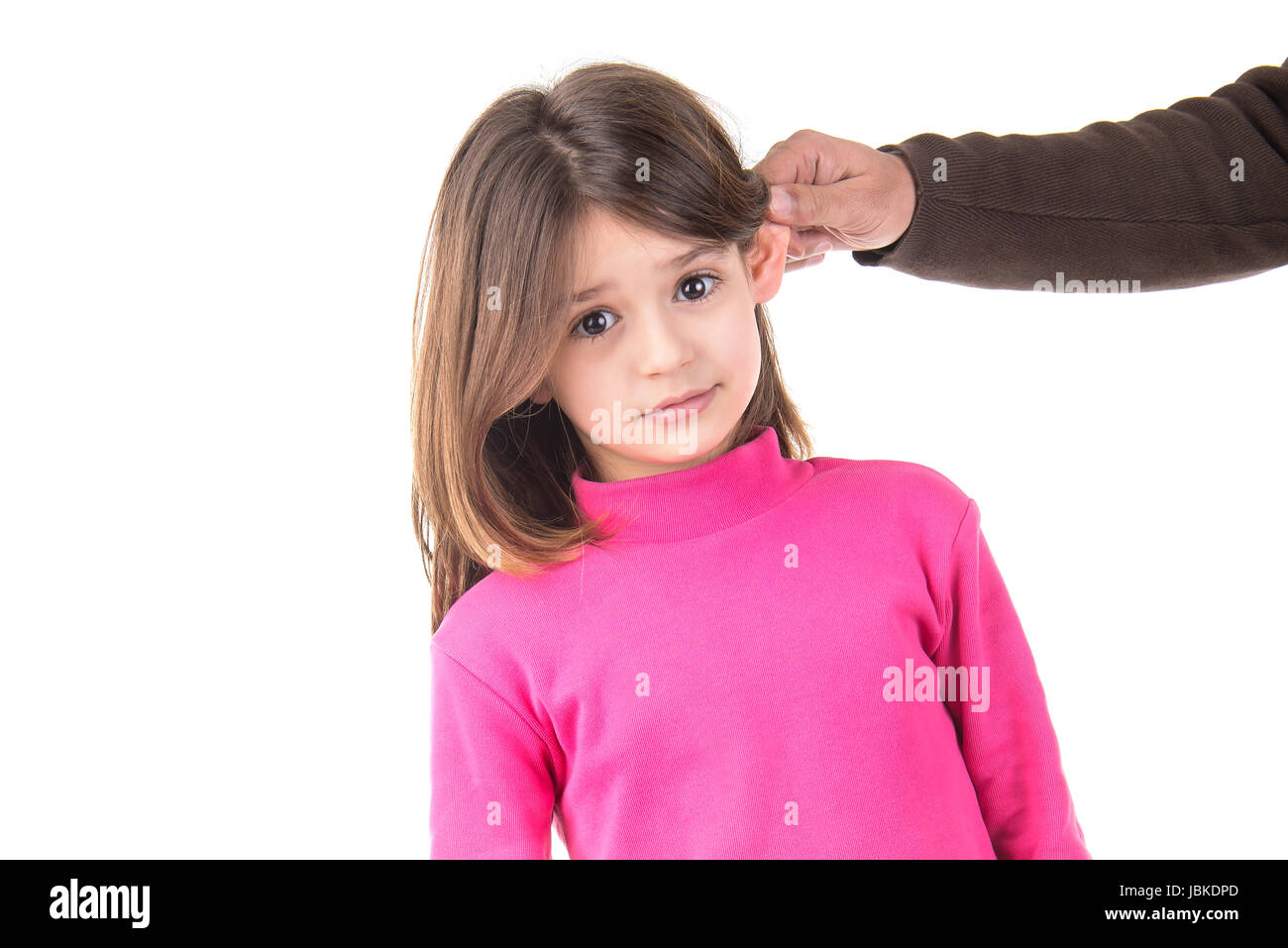 Young girl being punished with ear pulling Stock Photo Alamy