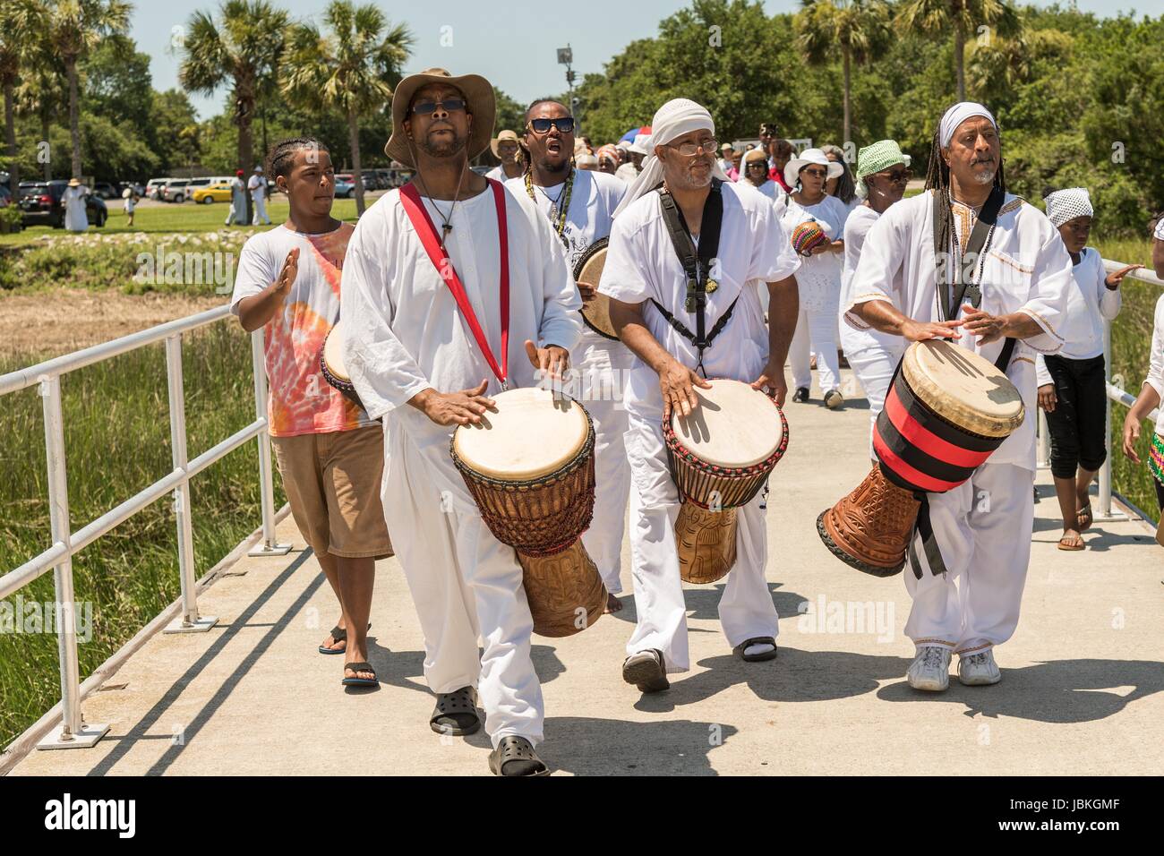 Descendants of enslaved Africans brought to Charleston in the Middle Passage hold a procession to honor their relatives lost during a remembrance ceremony at Fort Moultie National Monument June 10, 2017 in Sullivan's Island, South Carolina. The Middle Passage refers to the triangular trade in which millions of Africans were shipped to the New World as part of the Atlantic slave trade. An estimated 15% of the Africans died at sea and considerably more in the process of capturing and transporting. The total number of African deaths directly attributable to the Middle Passage voyage is estimated  Stock Photo