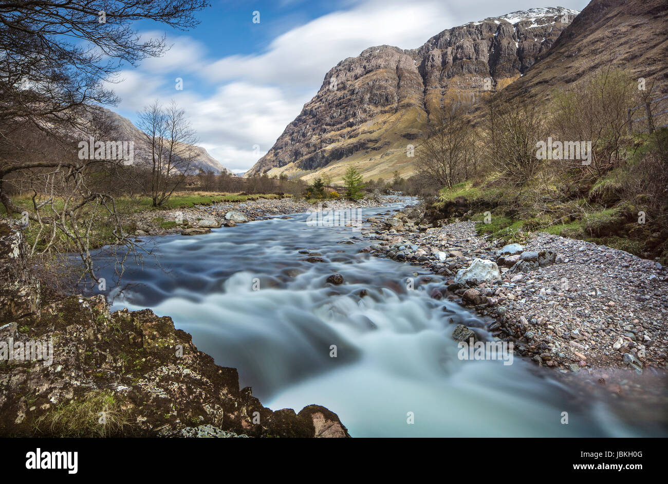 River Coe, Glencoe, taken next to the Clachaig Inn, with Bidean nam Bian and Stop Coire Sgreamhaich mountains in the distance and rushing water Stock Photo