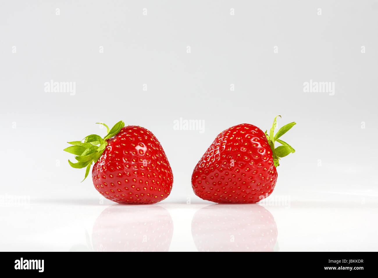 Two red strawberrys isolated on white background. Stock Photo