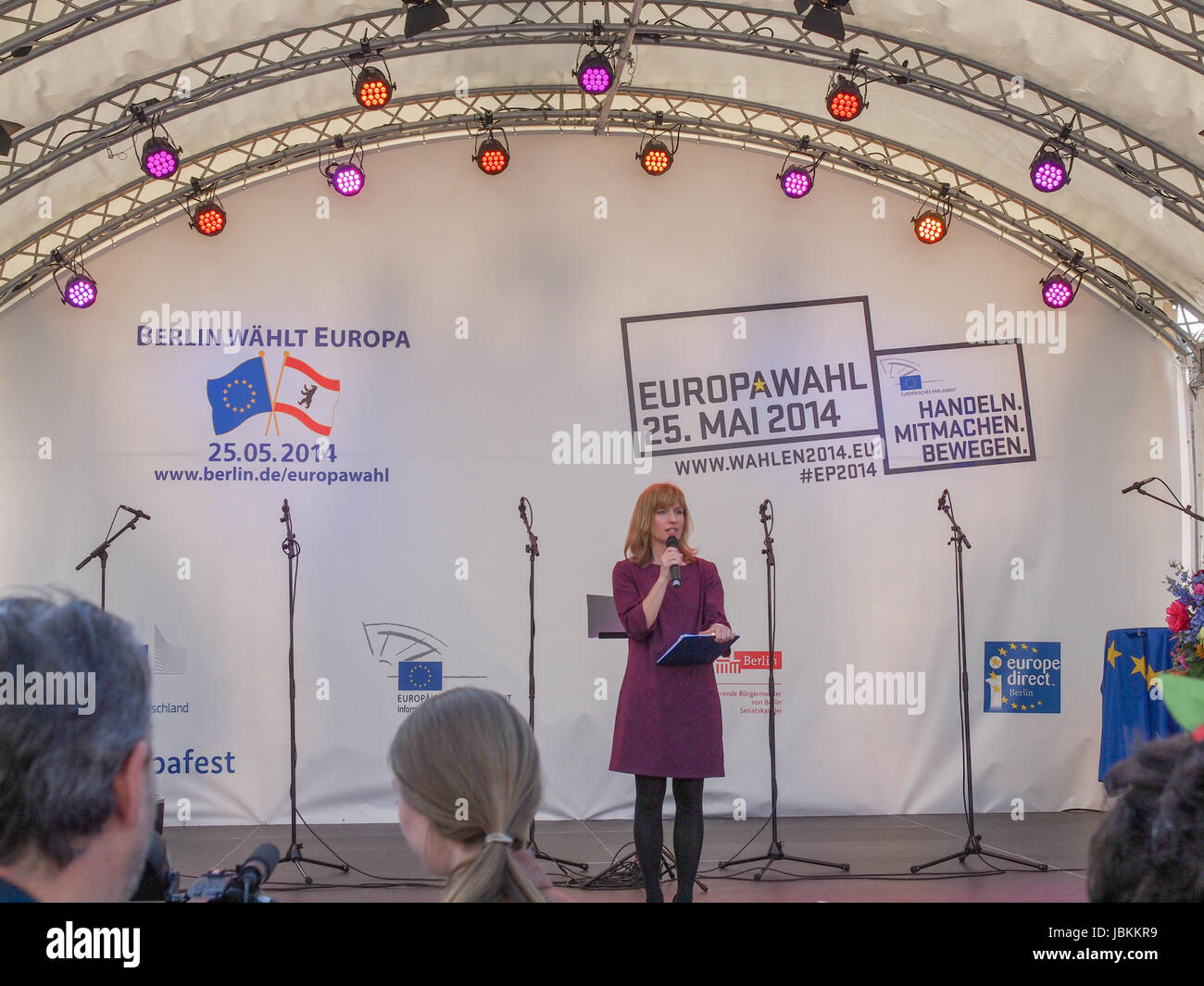 BERLIN, GERMANY - MAY 09, 2014: Marion Pinkpank from Radio Berlin moderating the Europafest at Brandenburg Gate for the forthcoming European elections (Europawahl). Berlin waehlt Europa means Berlin elects Europe. Handeln Mitmachen Bewegen means Act Join Move. Stock Photo