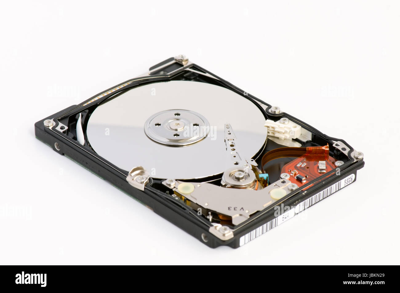 Opened hard disk showing the disk surface and drive head Stock Photo