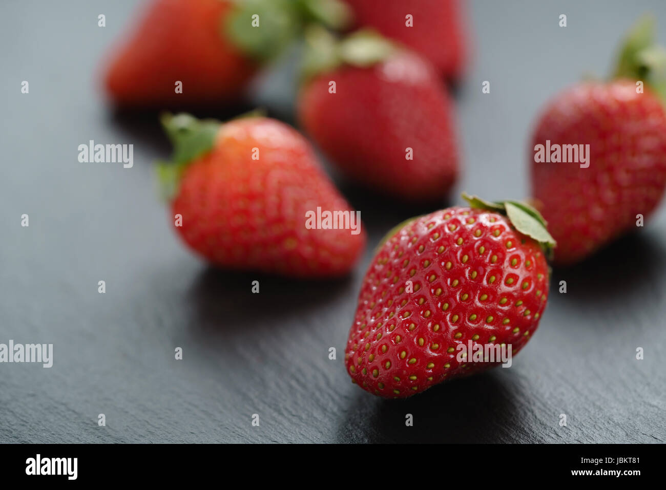 ripe organic strawberries on slate background Stock Photo - Alamy