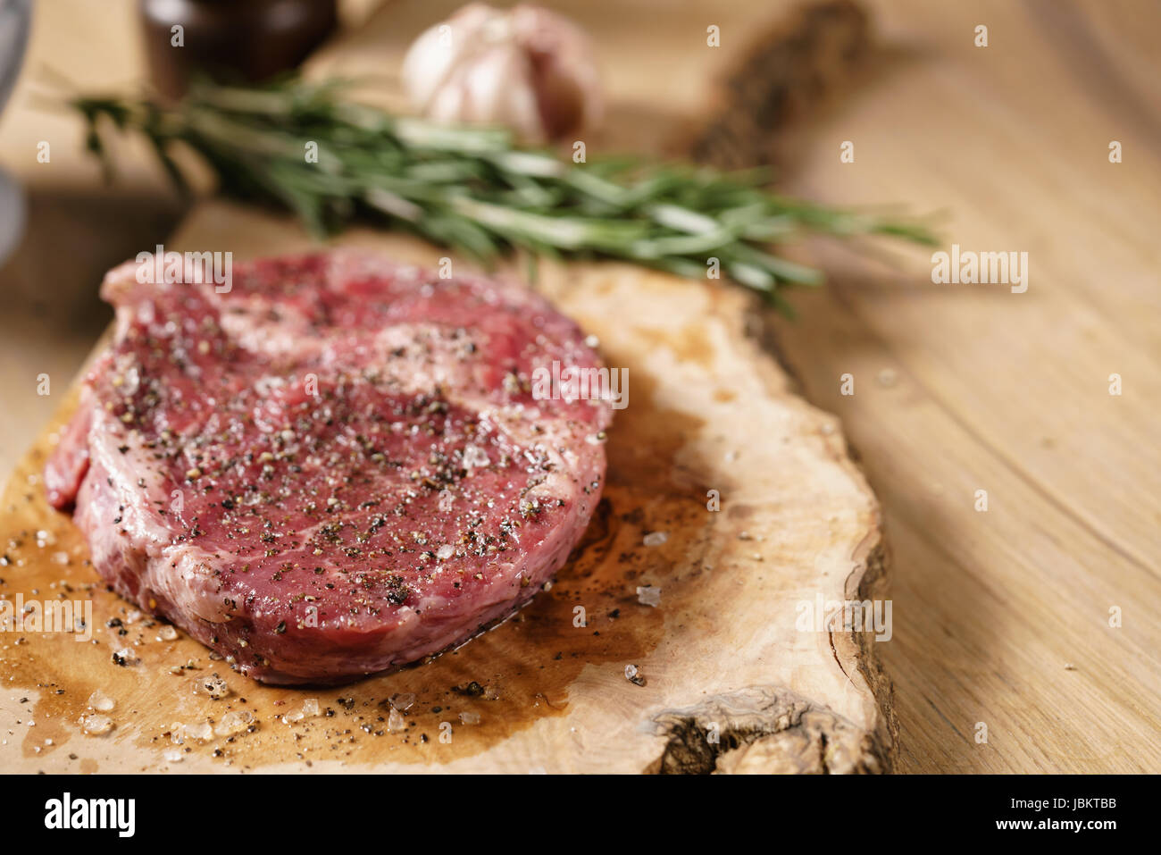 raw rib eye steak on board closeup Stock Photo