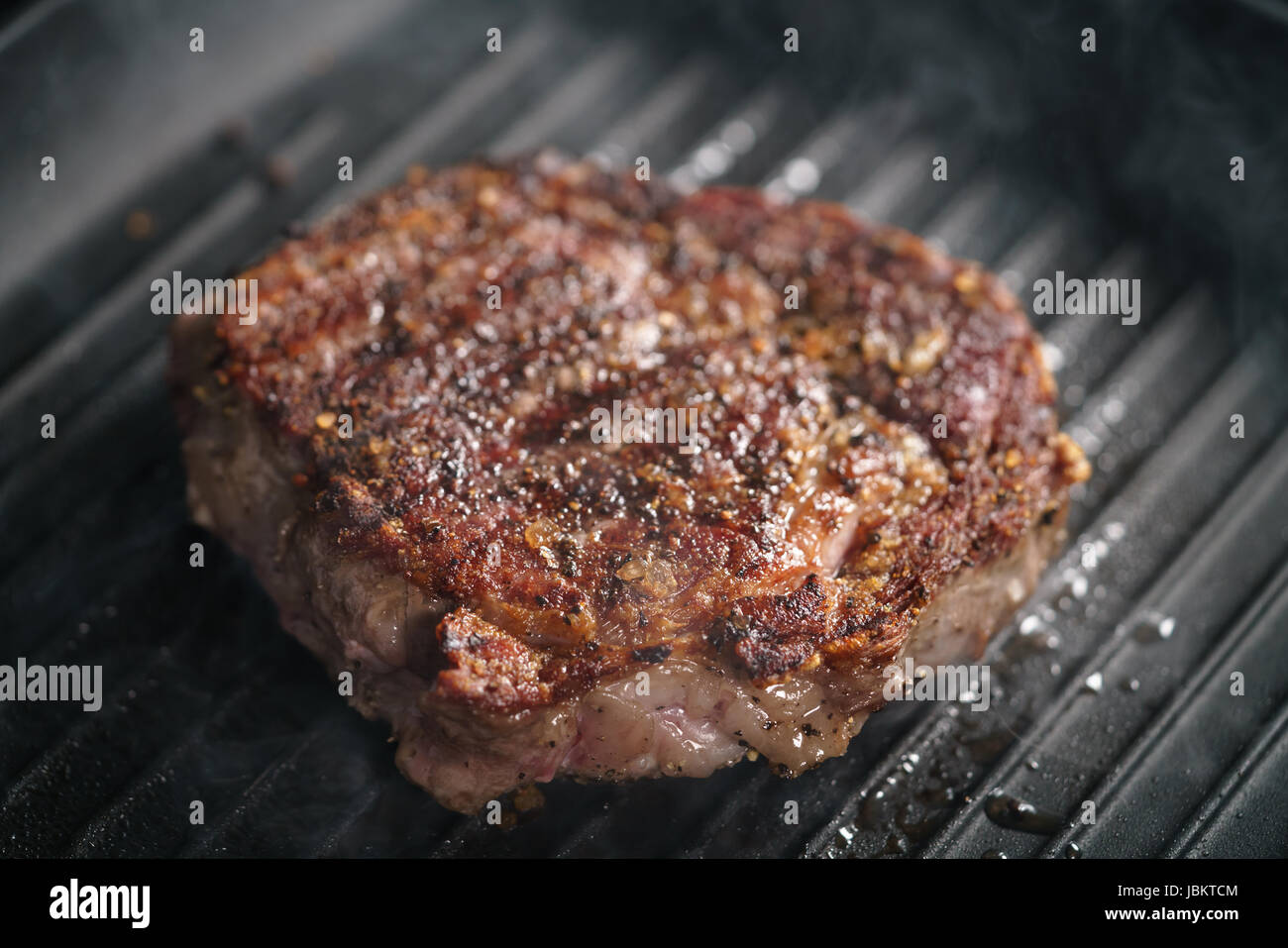 beef rib eye steak on grill pan closeup Stock Photo Alamy