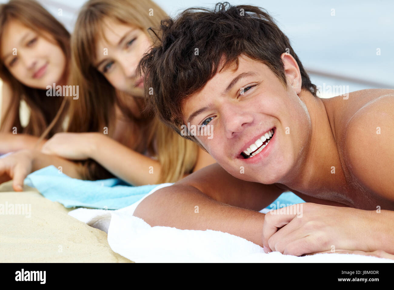 Portrait Of Three Teenage Friends Lying On The Beach And Sunbathing   Portrait Of Three Teenage Friends Lying On The Beach And Sunbathing JBM0DR 