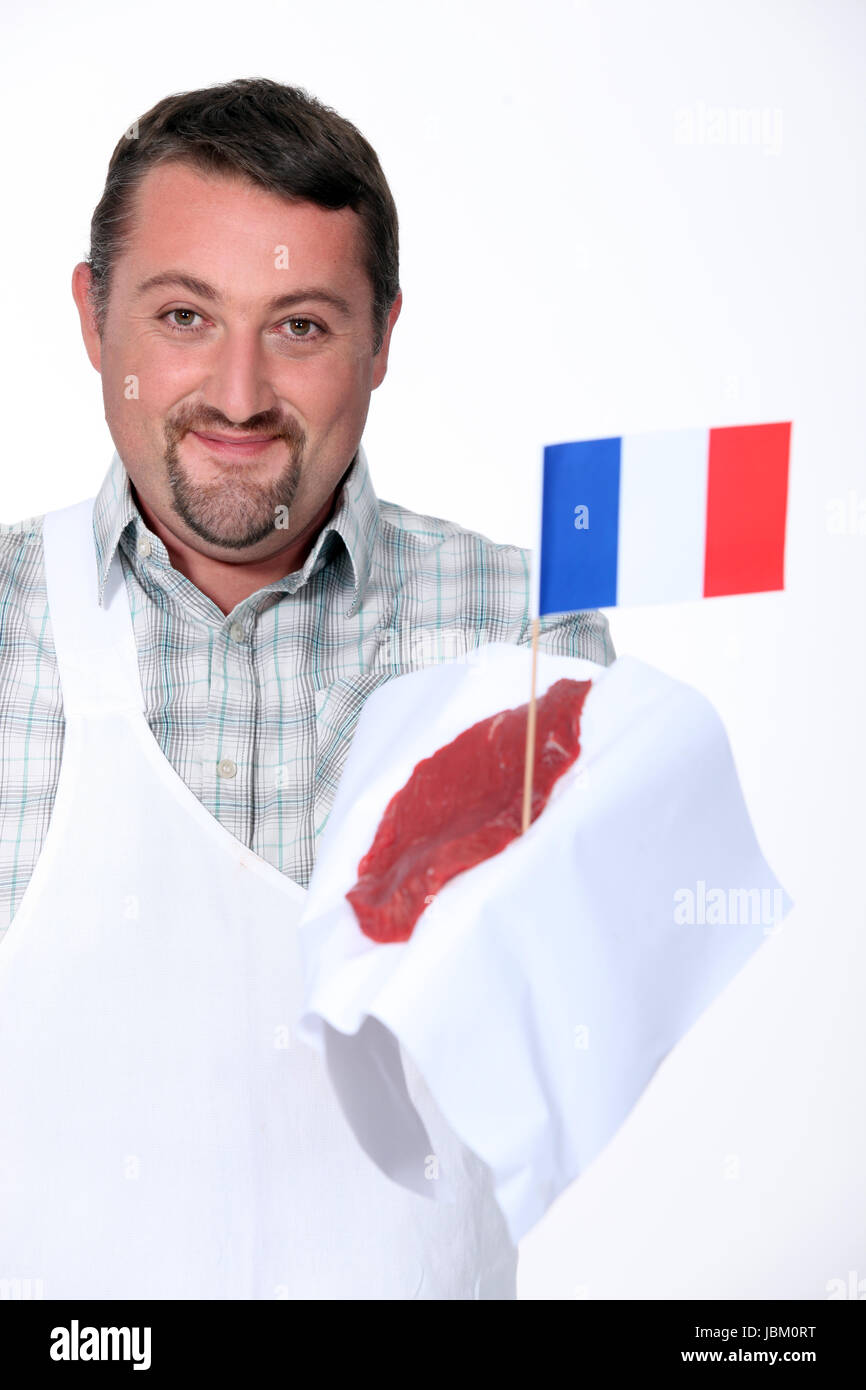 Butcher holding French beef Stock Photo Alamy