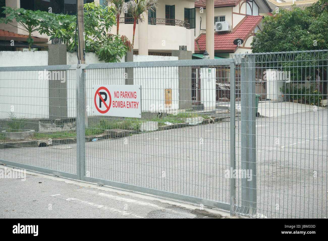 fences erected in Malaysian housing area to prevent break in and restrict strangers. Stock Photo