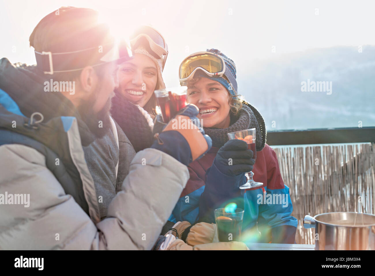 Smiling skier friends drinking cocktails apres-ski Stock Photo