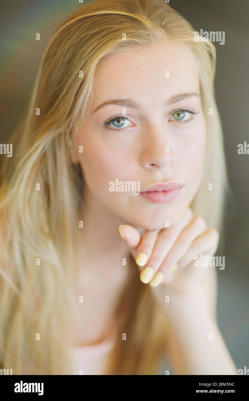 Portrait serious beautiful blonde teenage girl Stock Photo