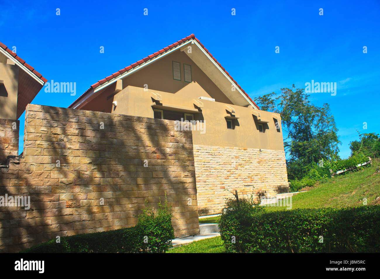 modern bricks house, patio with columns and garden Stock Photo Alamy