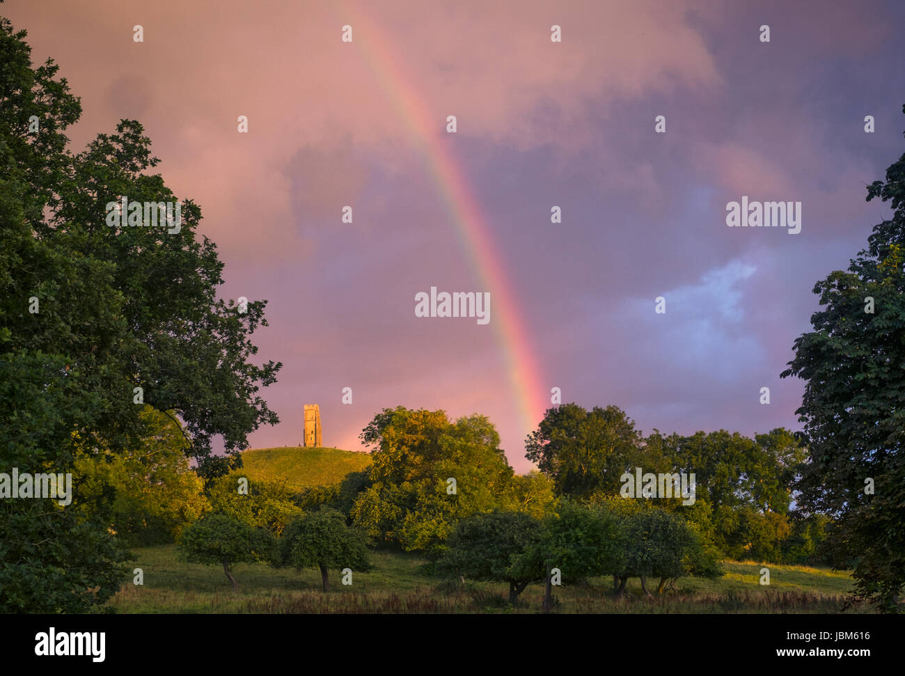 Tranquil rainbow over rural countryside park Stock Photo
